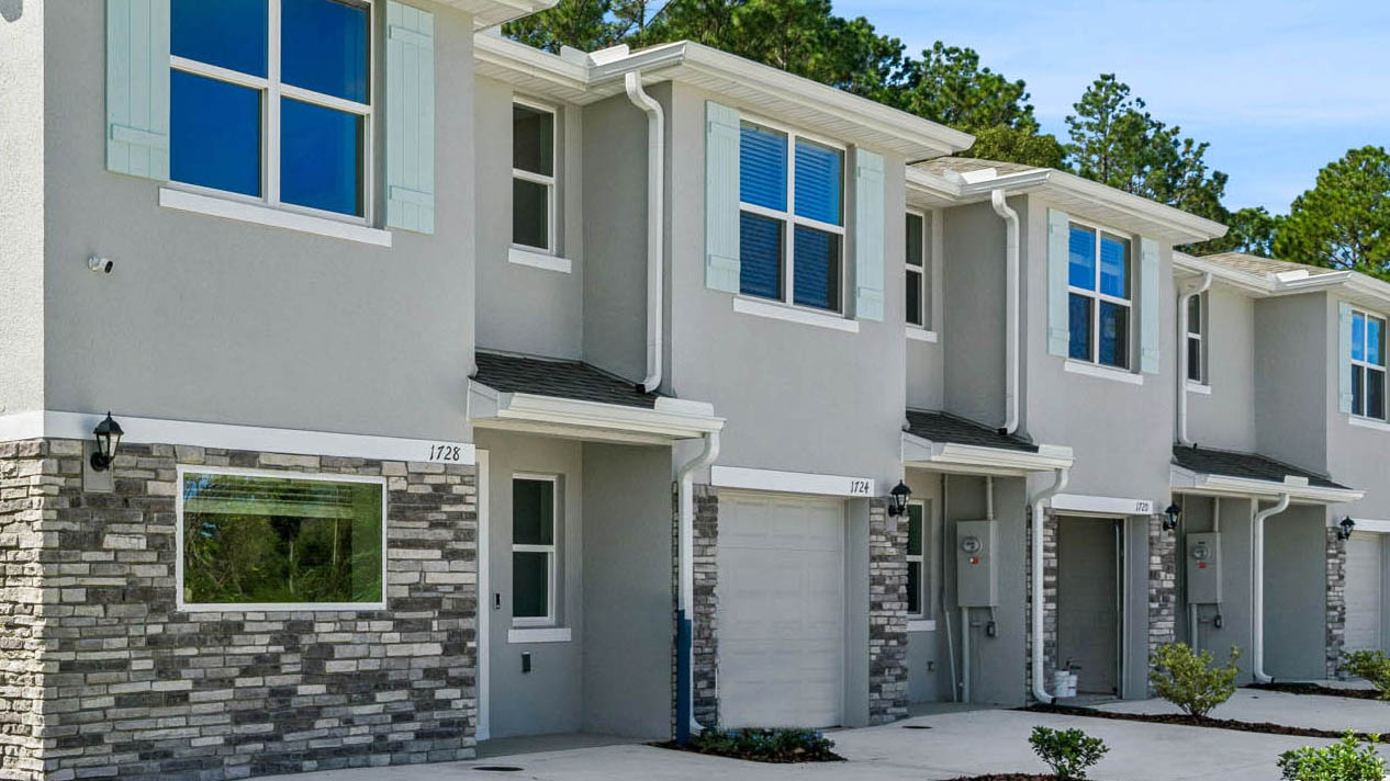Attached townhome with concrete block construction and a one-car garage.