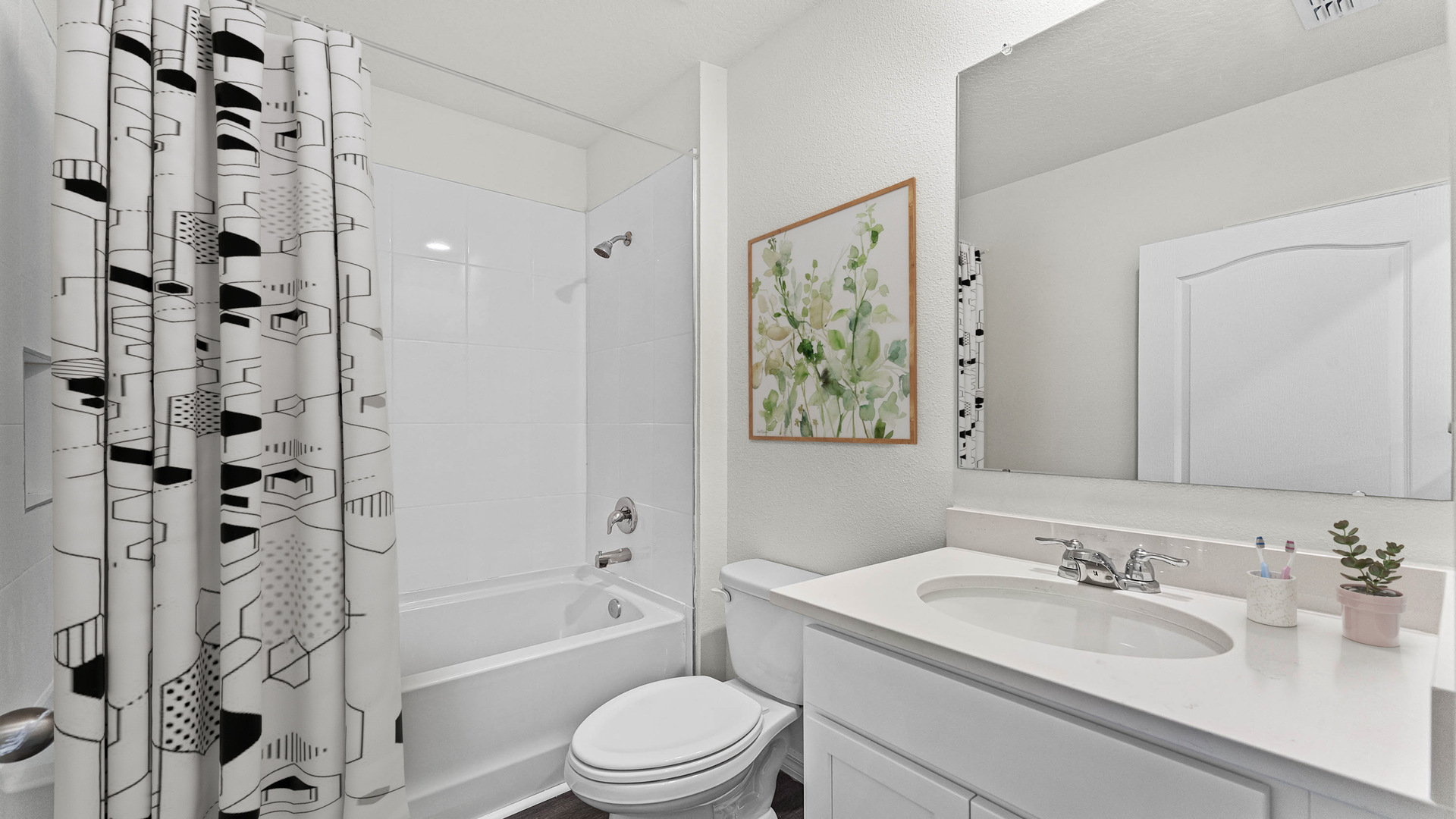 master bathroom showing double vanity with quartz countertops with access to walk-in closet.