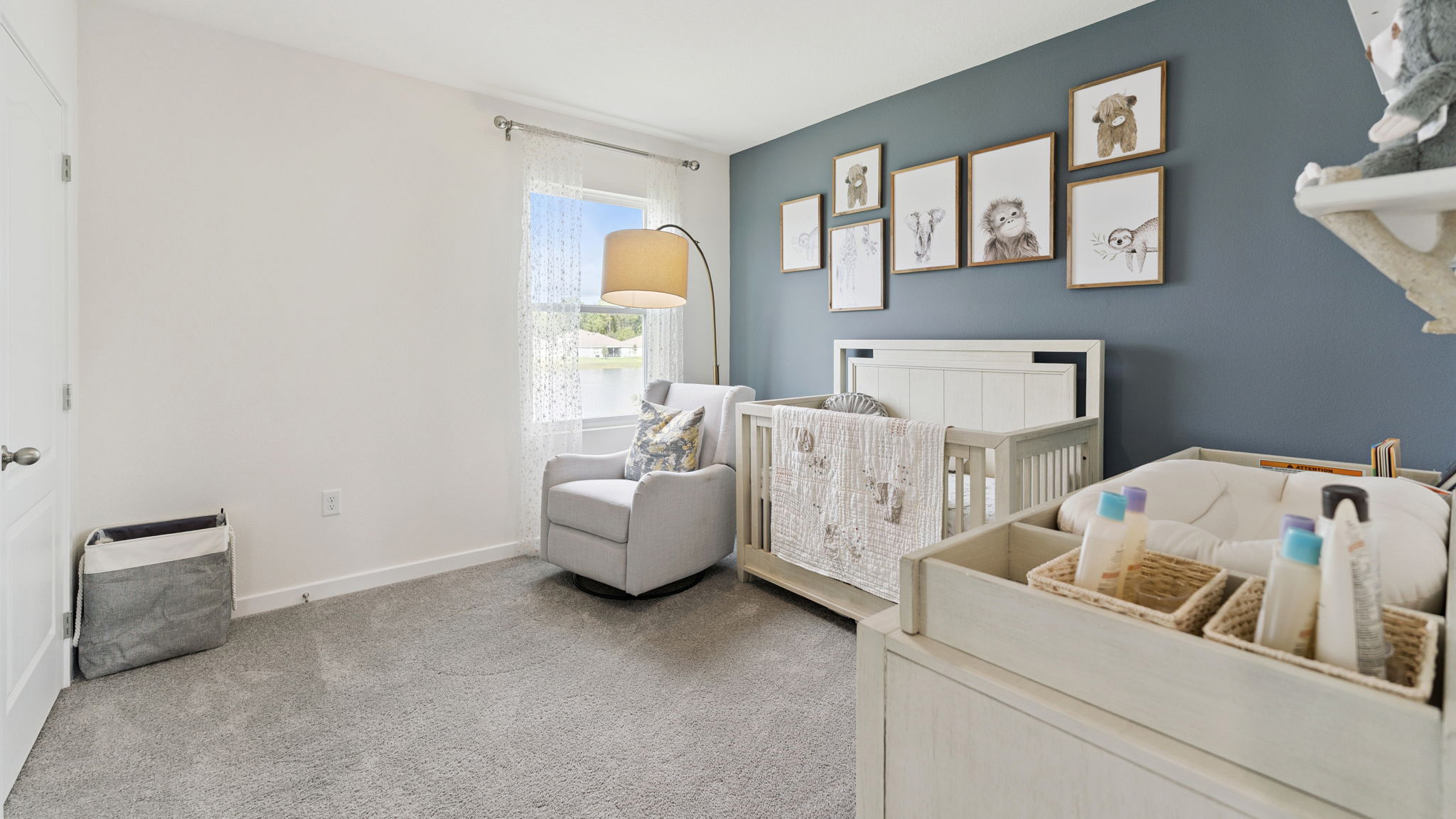 Guest bedroom with bed, nighstand, desk, and natural lighting with spacious closet.