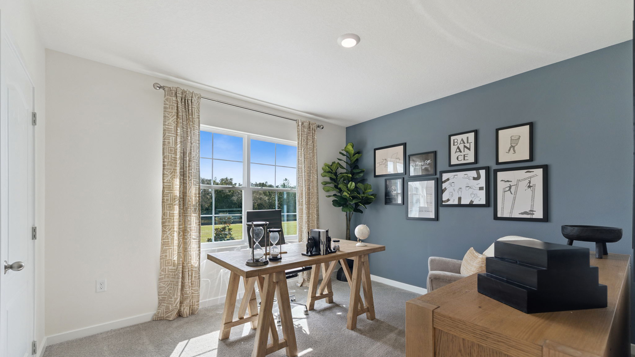 Functional home office with desk, chairs and space to work or play.