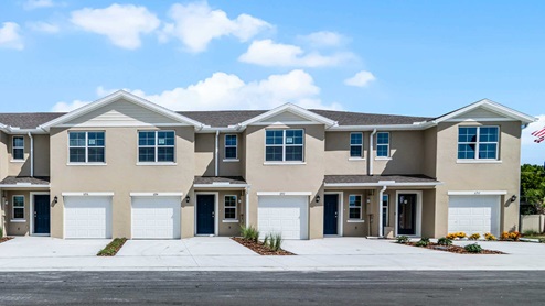 Attached townhome with concrete block construction and a one-car garage.