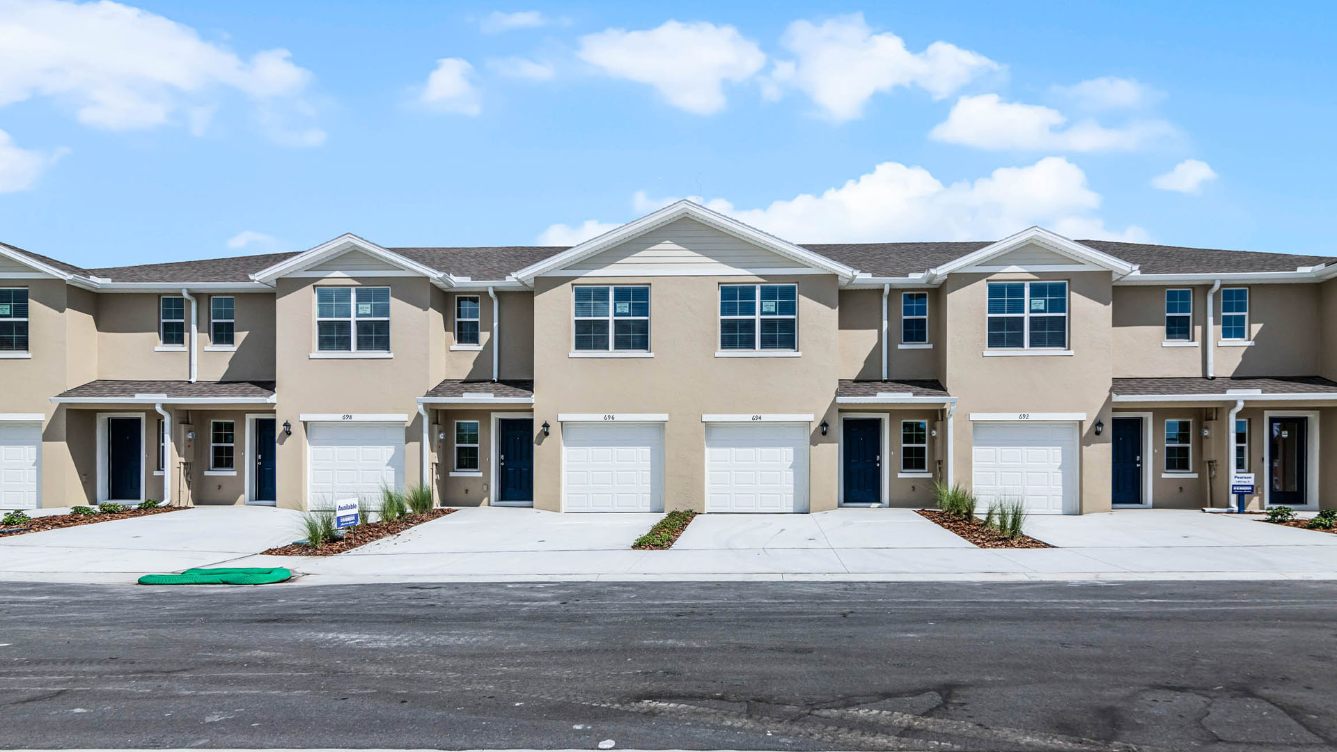 Attached townhome with concrete block construction and a one-car garage.