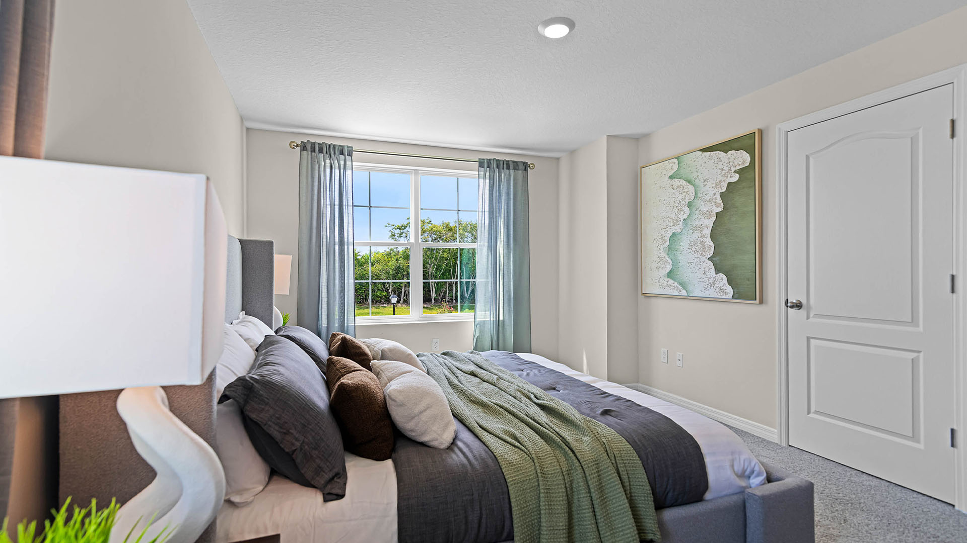 Guest bedroom with bed, nightstands and a roomy closet for storage.