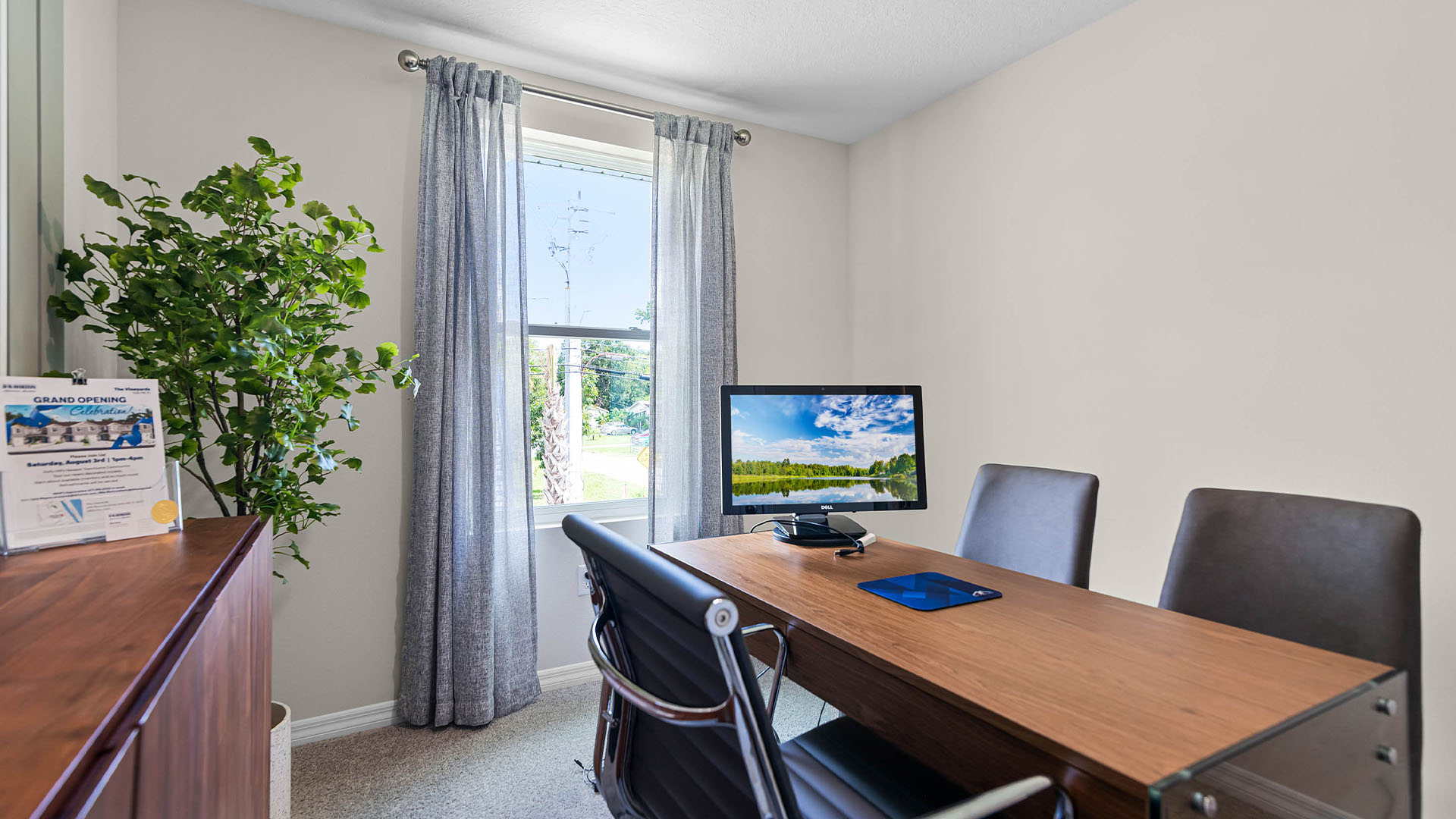 Functional home office with desk, chairs and space to work or play.