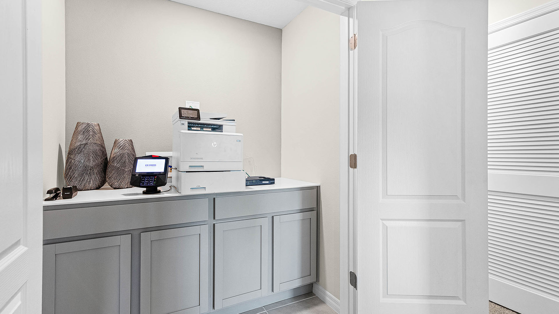 Laundry room with washer and dryer hookups and wall shelving.