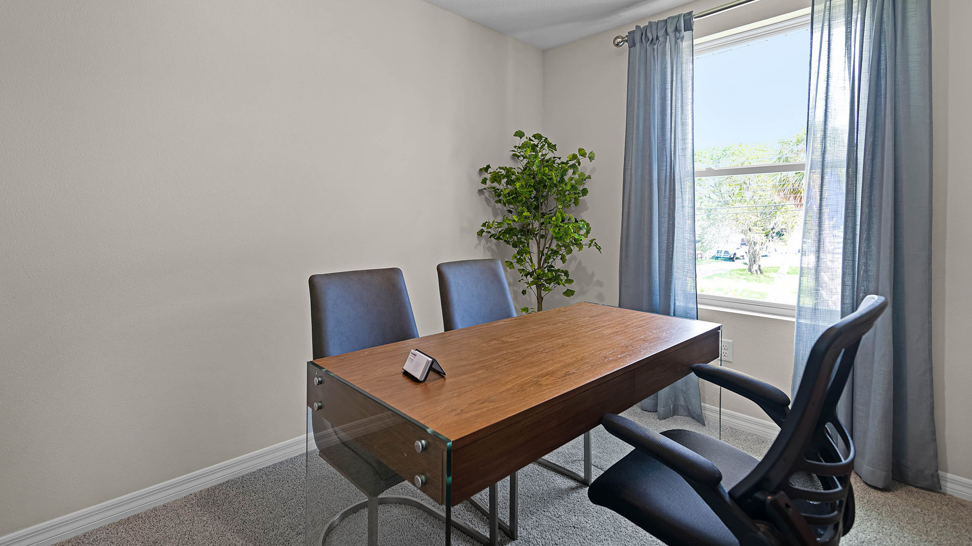 Functional home office with desk, chairs and space to work or play.