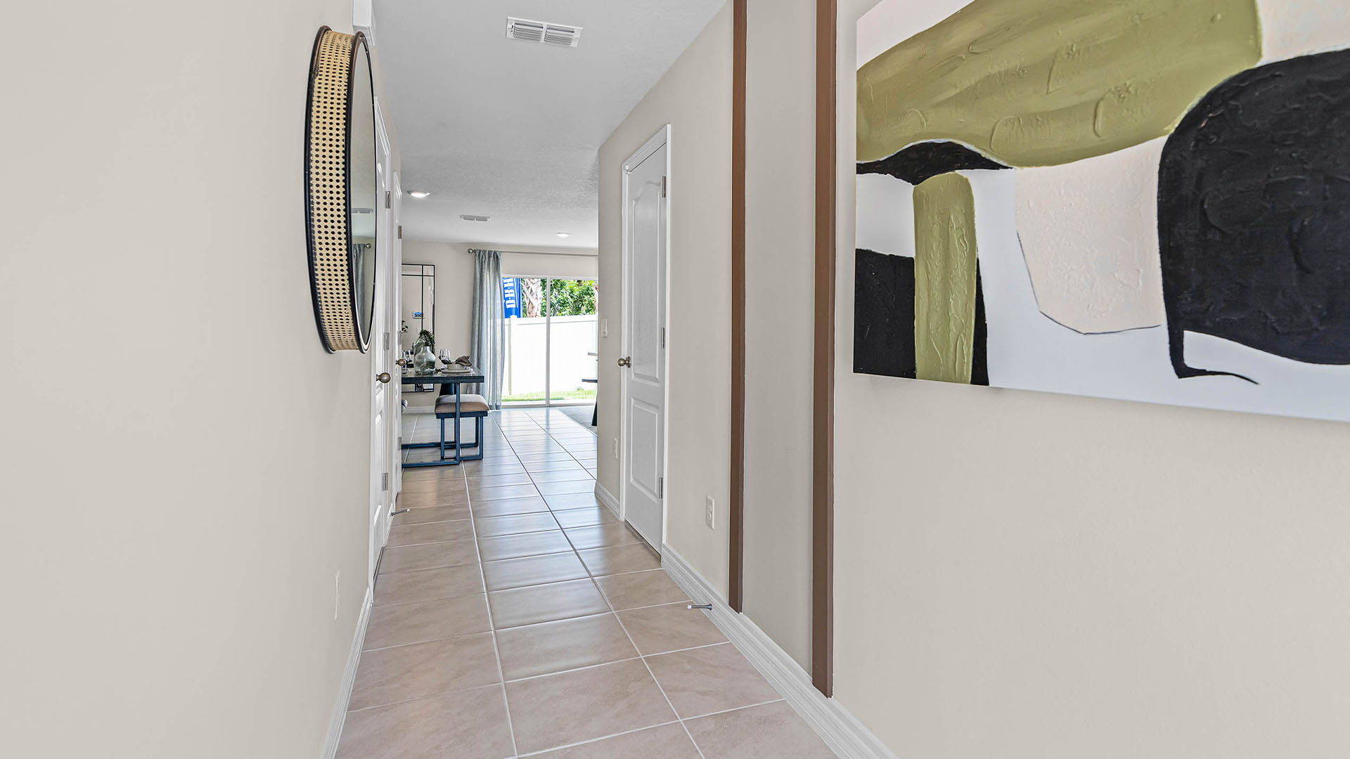Home entry way thru the front door with tile flooring and a view to the living space.