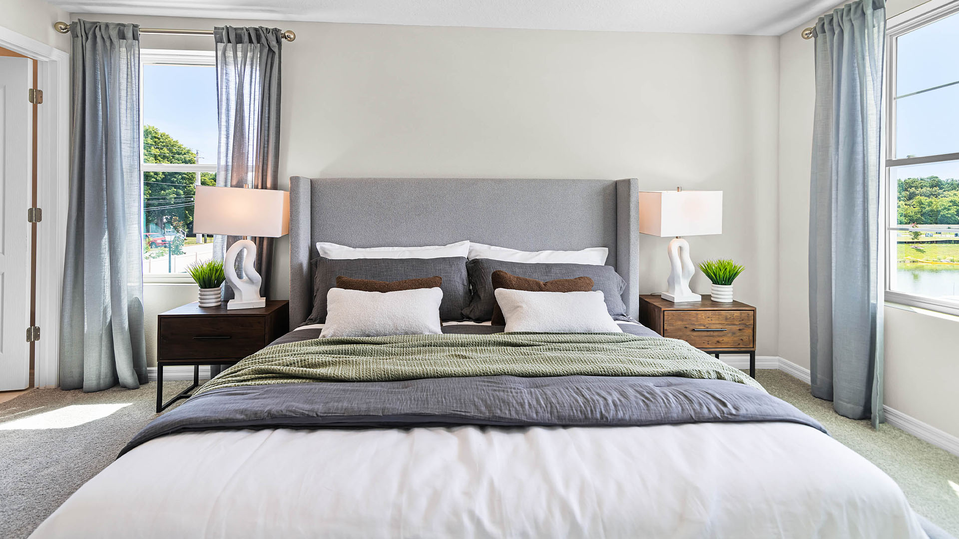 Single story new home with siding, covered porch and 2 car garage.