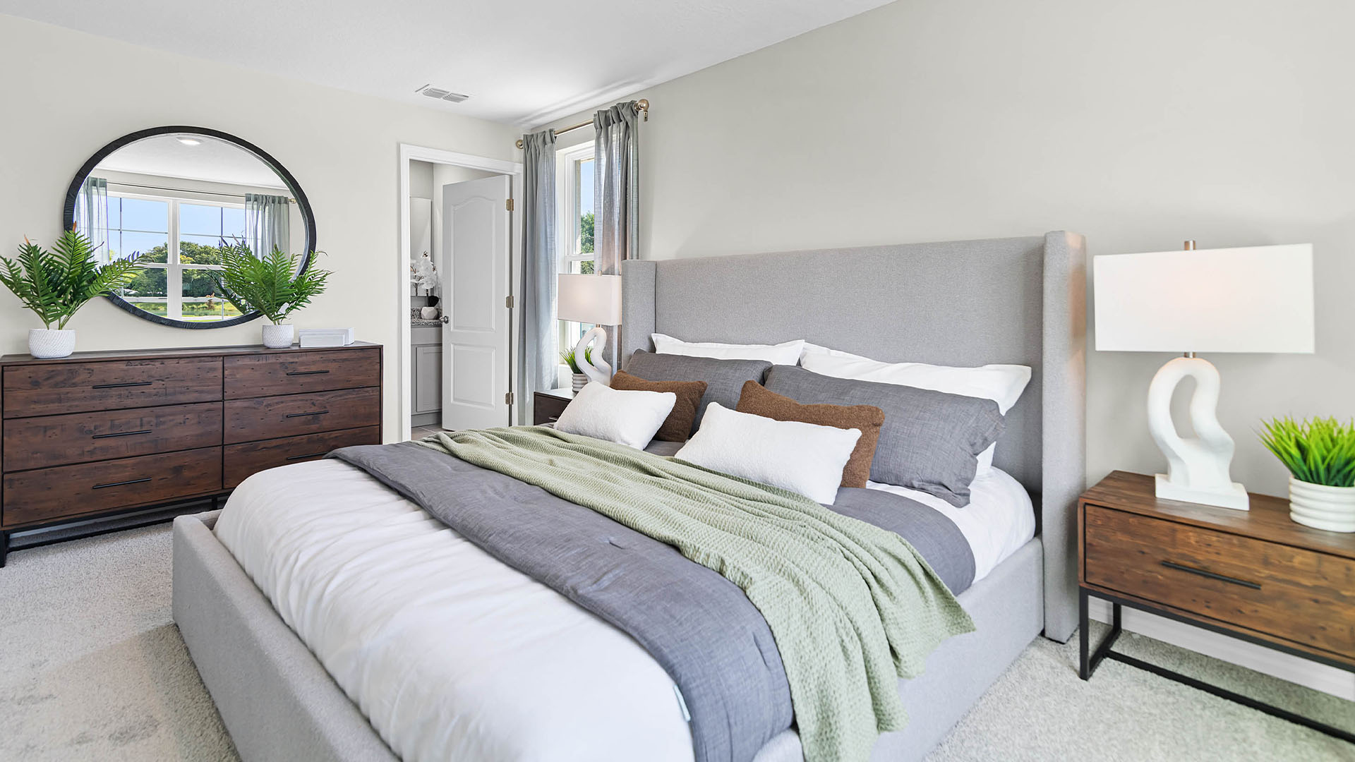 Single story new home with siding, covered porch and 2 car garage.