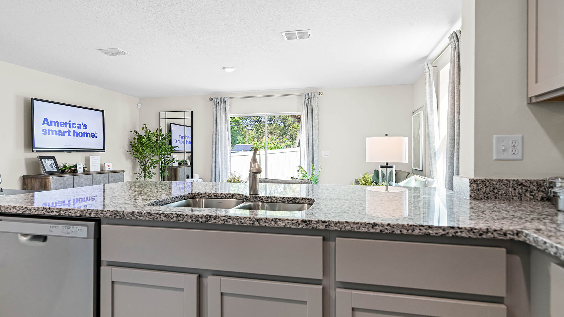 Kitchen with island seating, granite counters, spacious pantry and stainless-steel appliances.