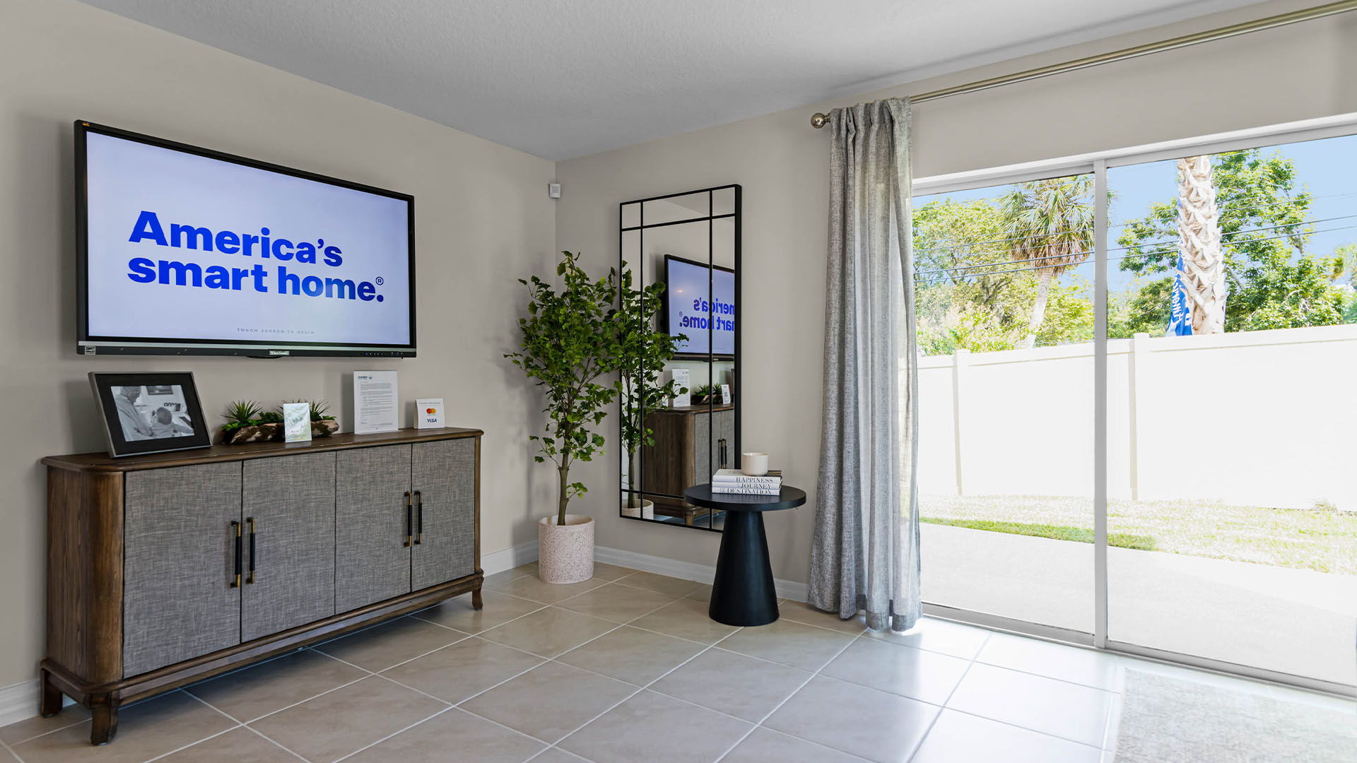 Open concept living area with couch seating and access to the backyard thru slider door.