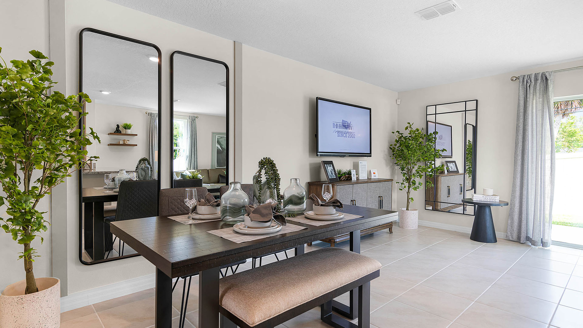 Dining room adjacent to the kitchen with table, chairs and tile flooring.