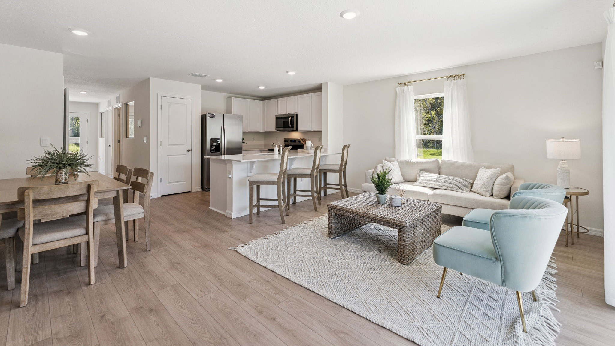 Living area with couch seating, entertainment system and natural lighting