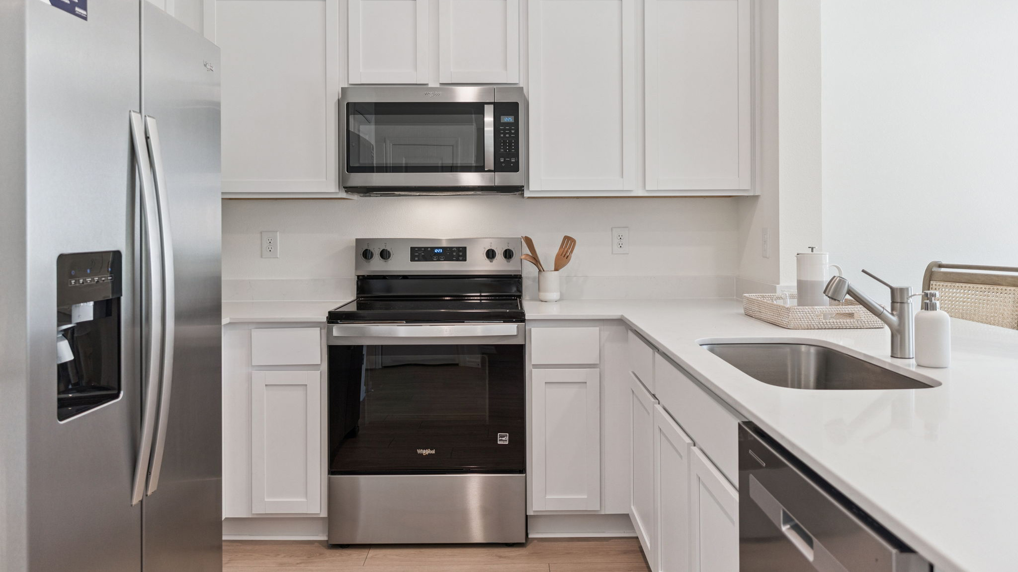 kitchen with quartz countertops overseeing living area and dining room table
