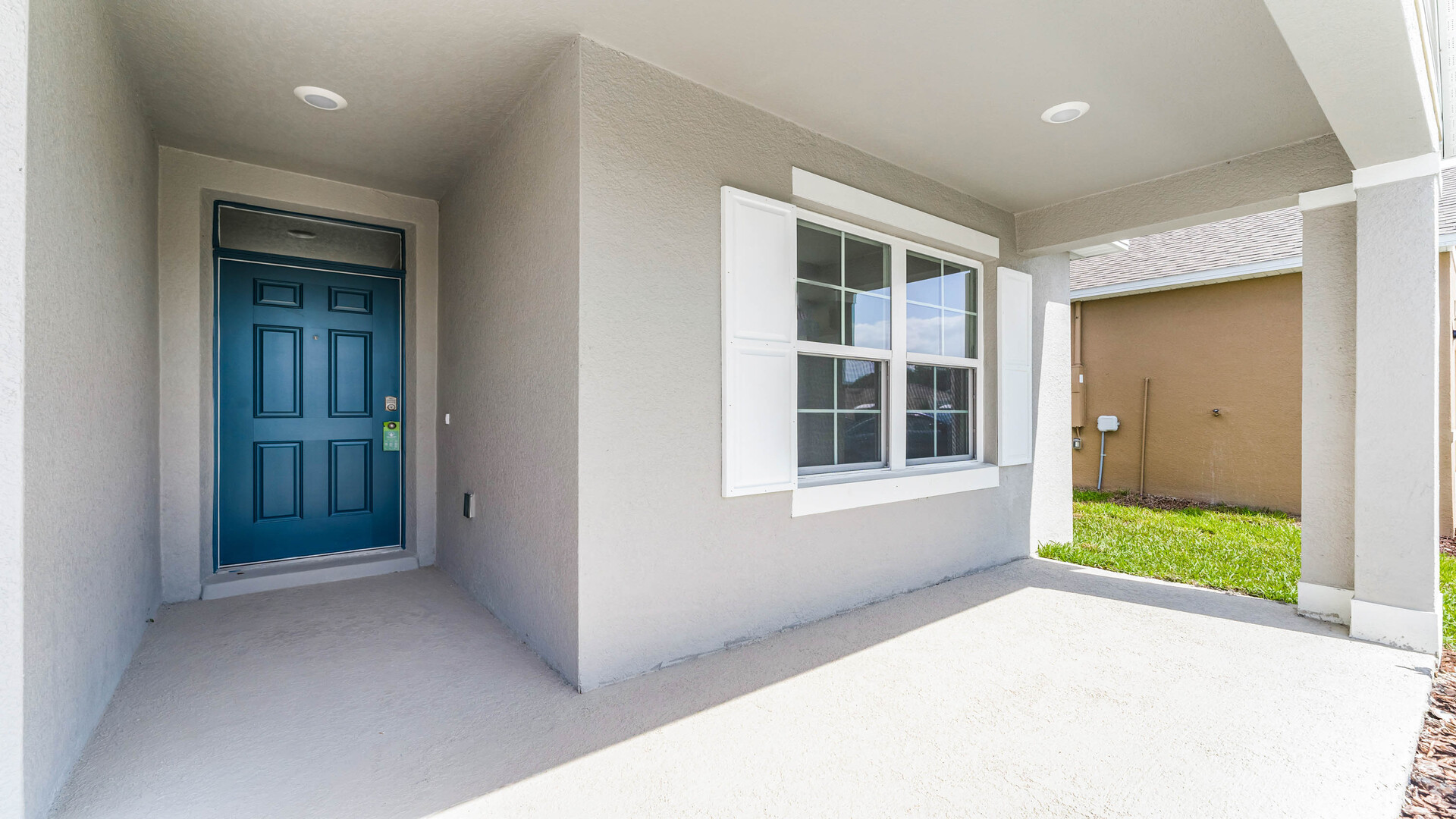 Home entry way thru the front door with tile flooring and a view to the living space.