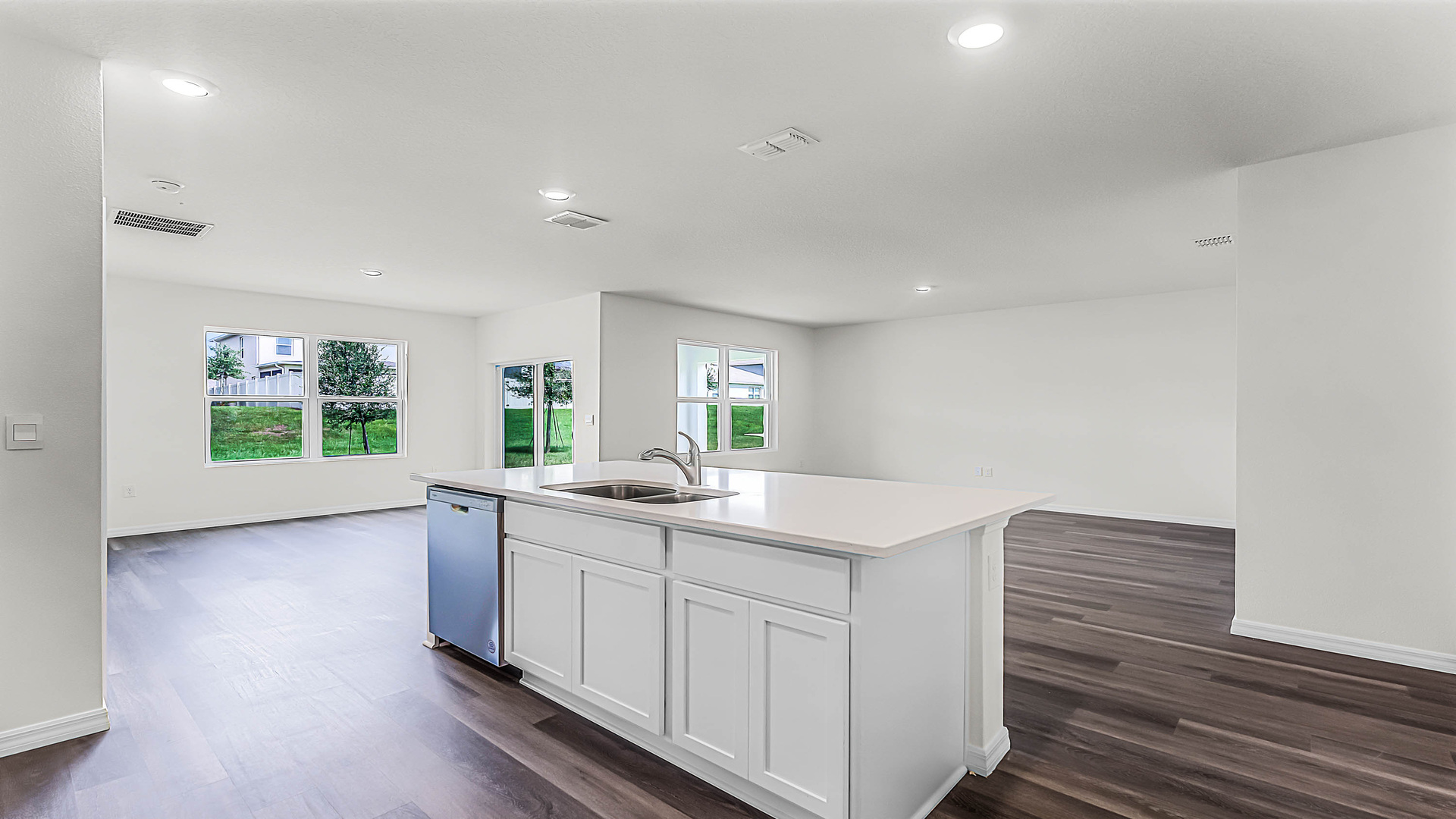 Kitchen with island seating, granite counters, spacious pantry and stainless-steel appliances.