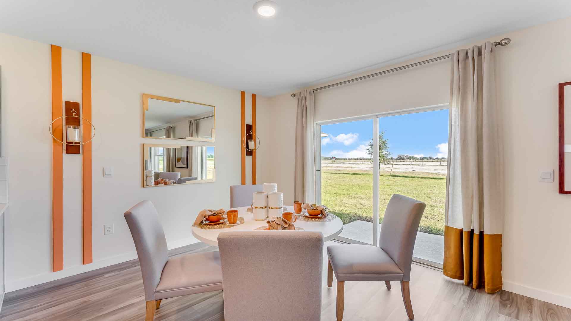 Kitchen with island seating, granite counters, spacious pantry and stainless-steel appliances.