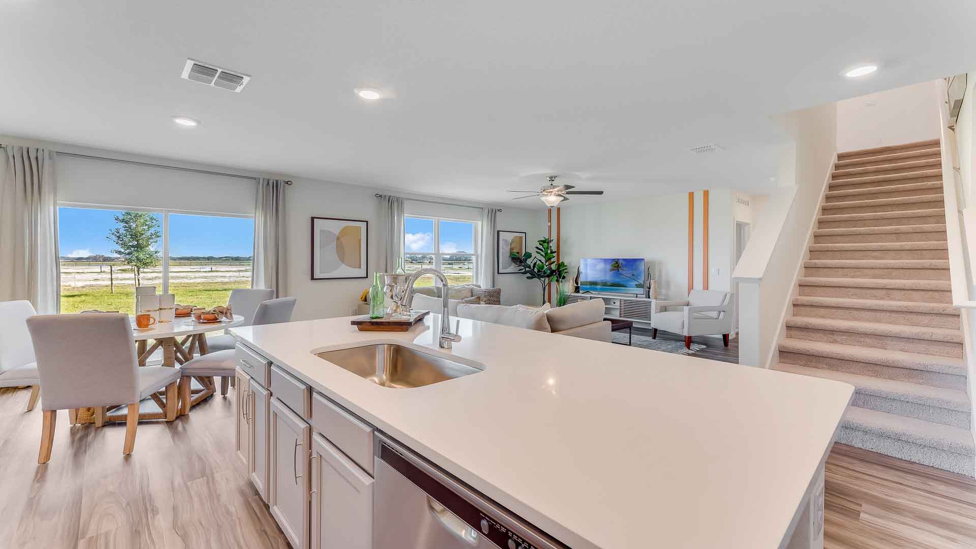 Kitchen with island seating, granite counters, spacious pantry and stainless-steel appliances.