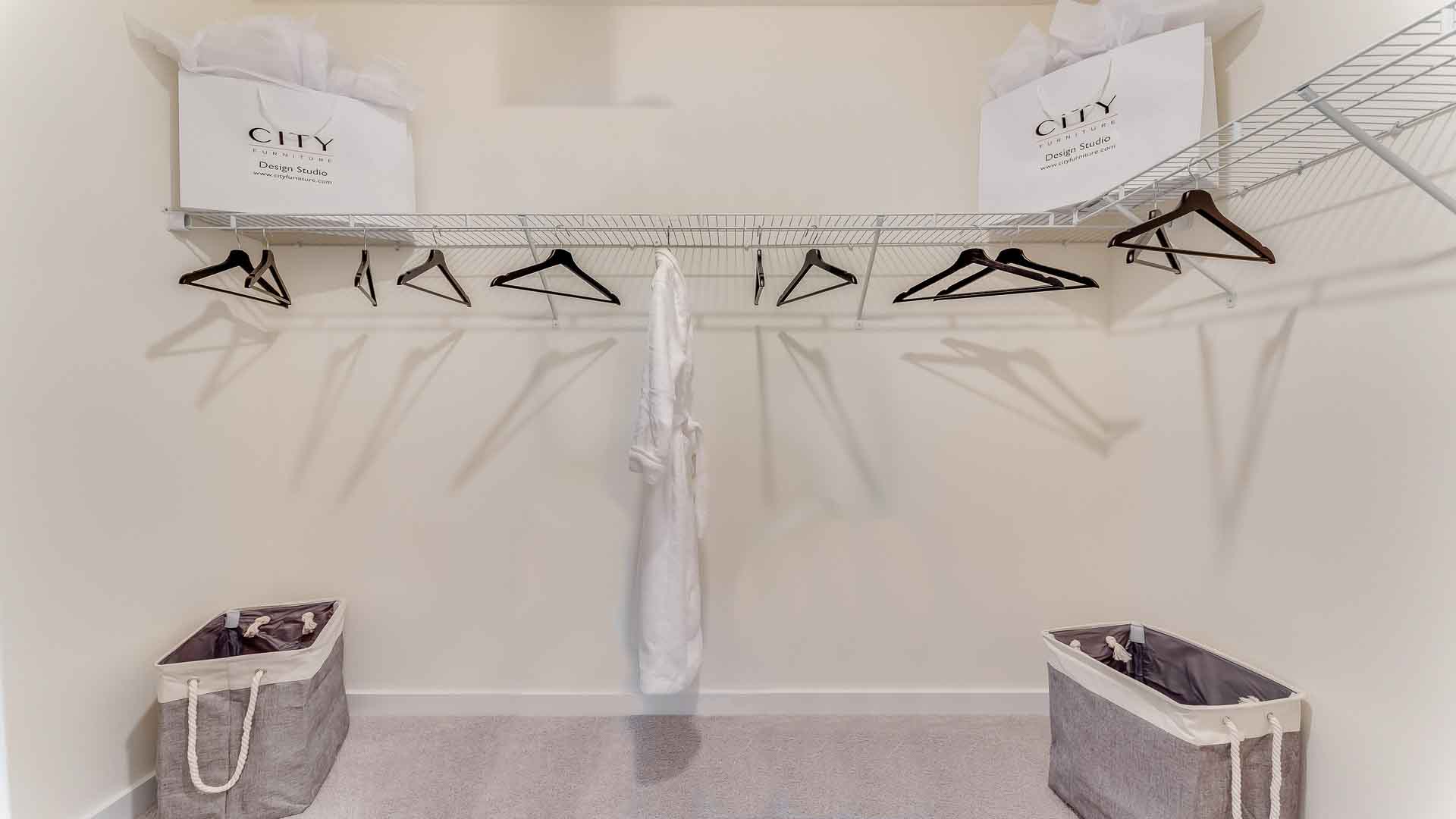 Spacious walk in closet with abundant shelving and storage.