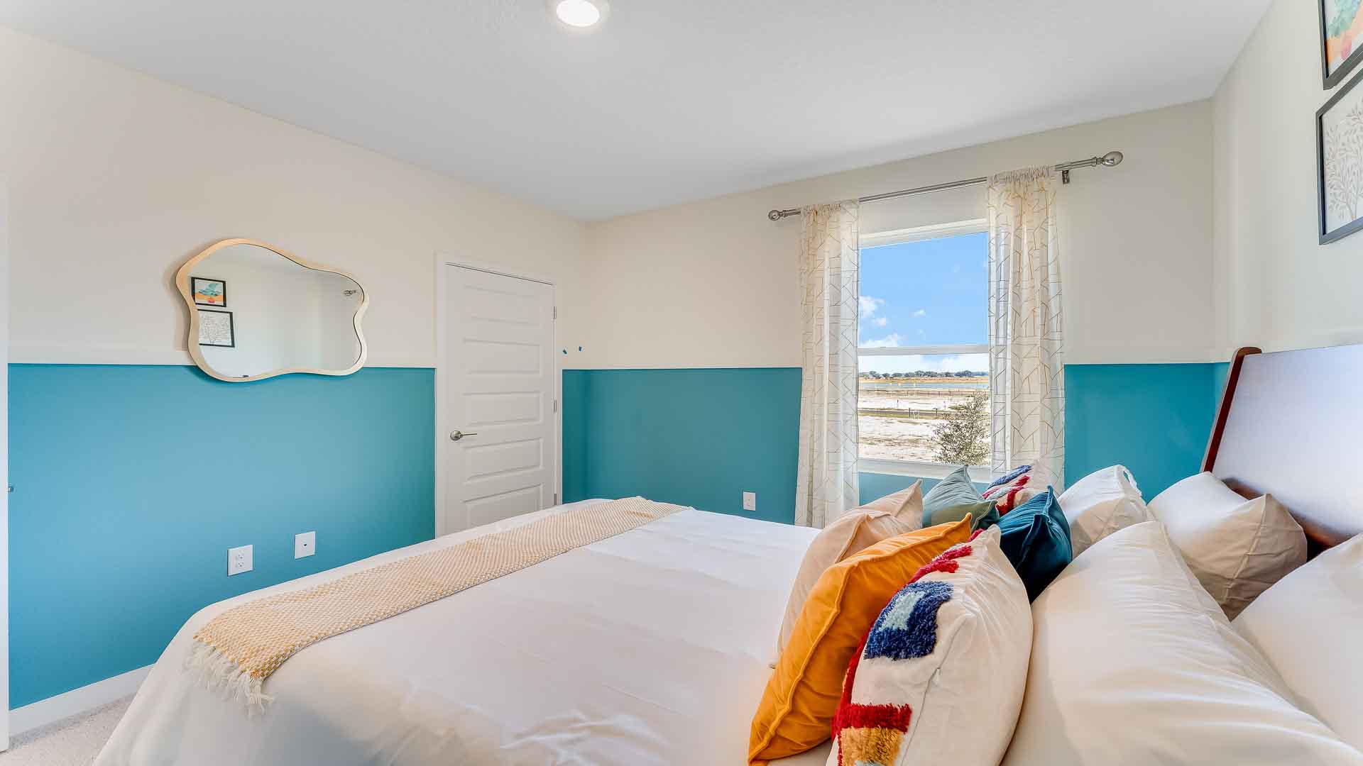 Guest bedroom with bed, nightstands and a roomy closet for storage.