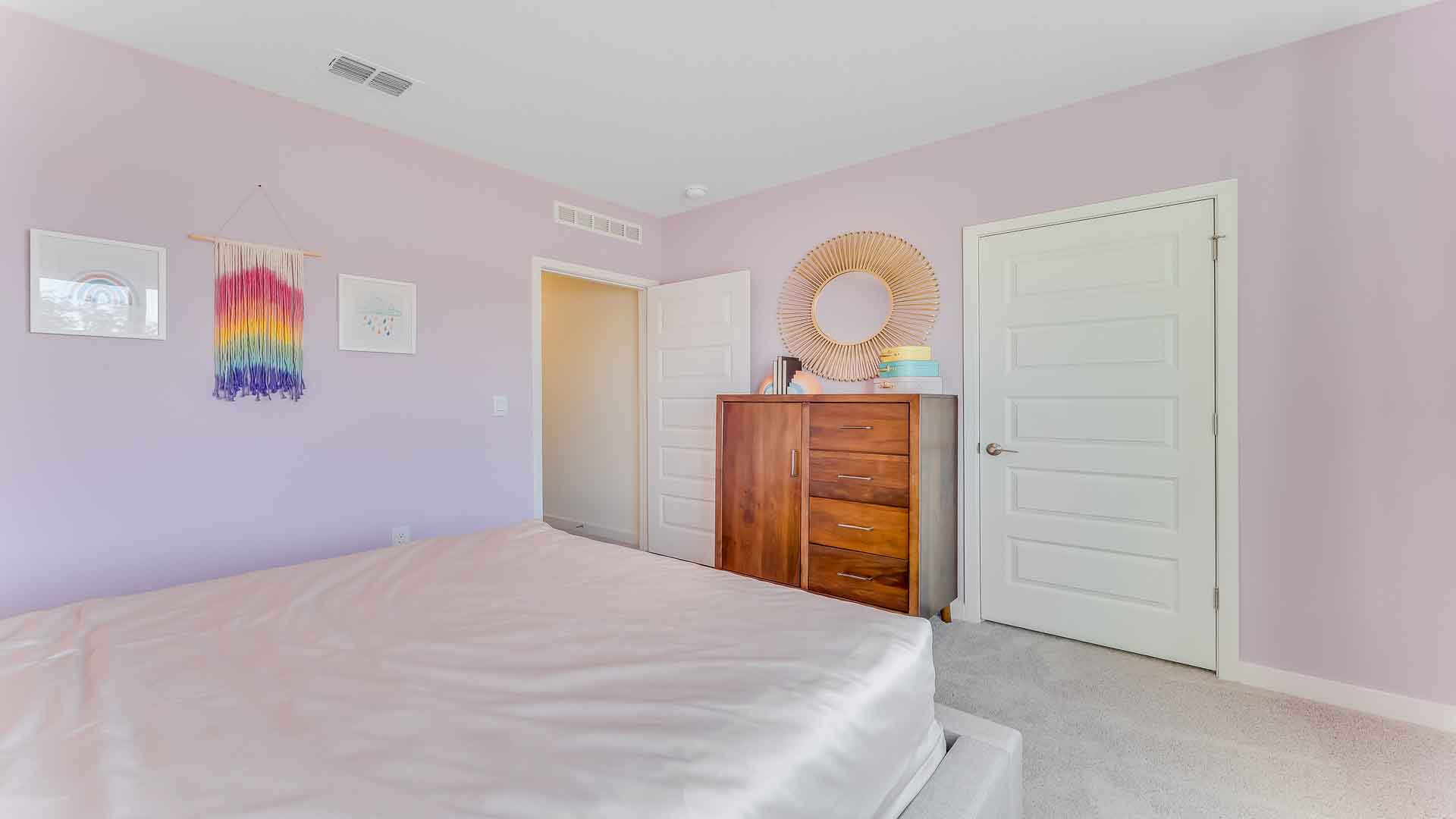 Child's room with toys, bedding, seating and storage and a spacious closet.