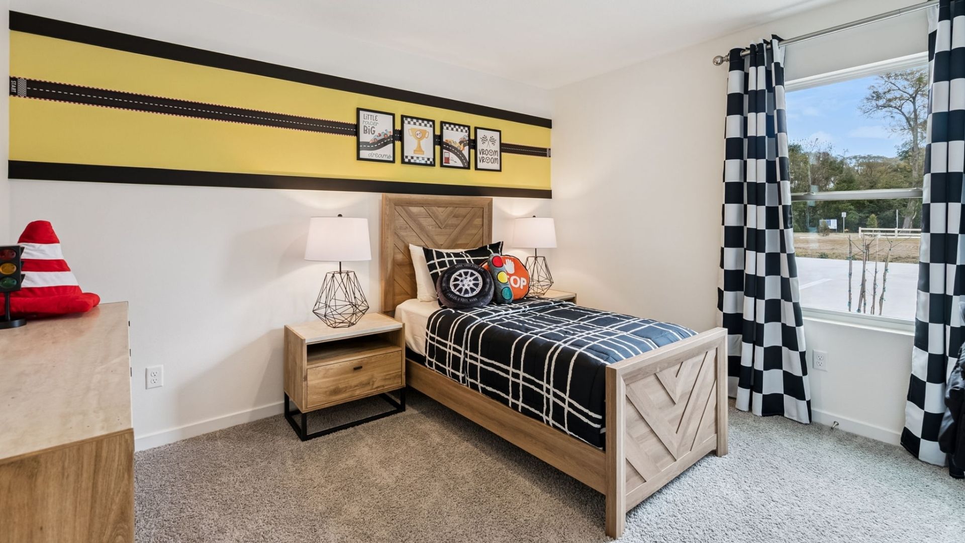 Spacious primary bedroom with king size bed, carpet flooring, natural lighting.