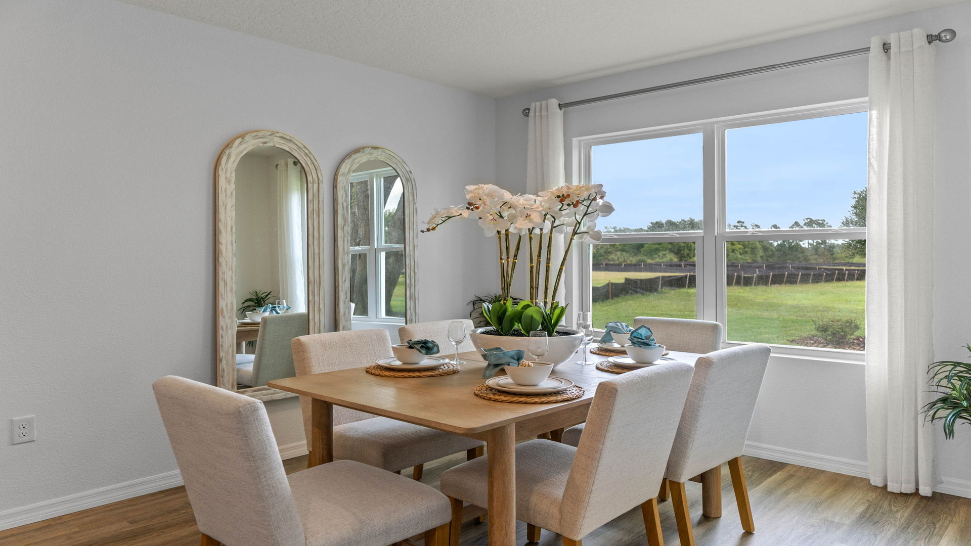 Dining room area with table, seating and natural lighting.