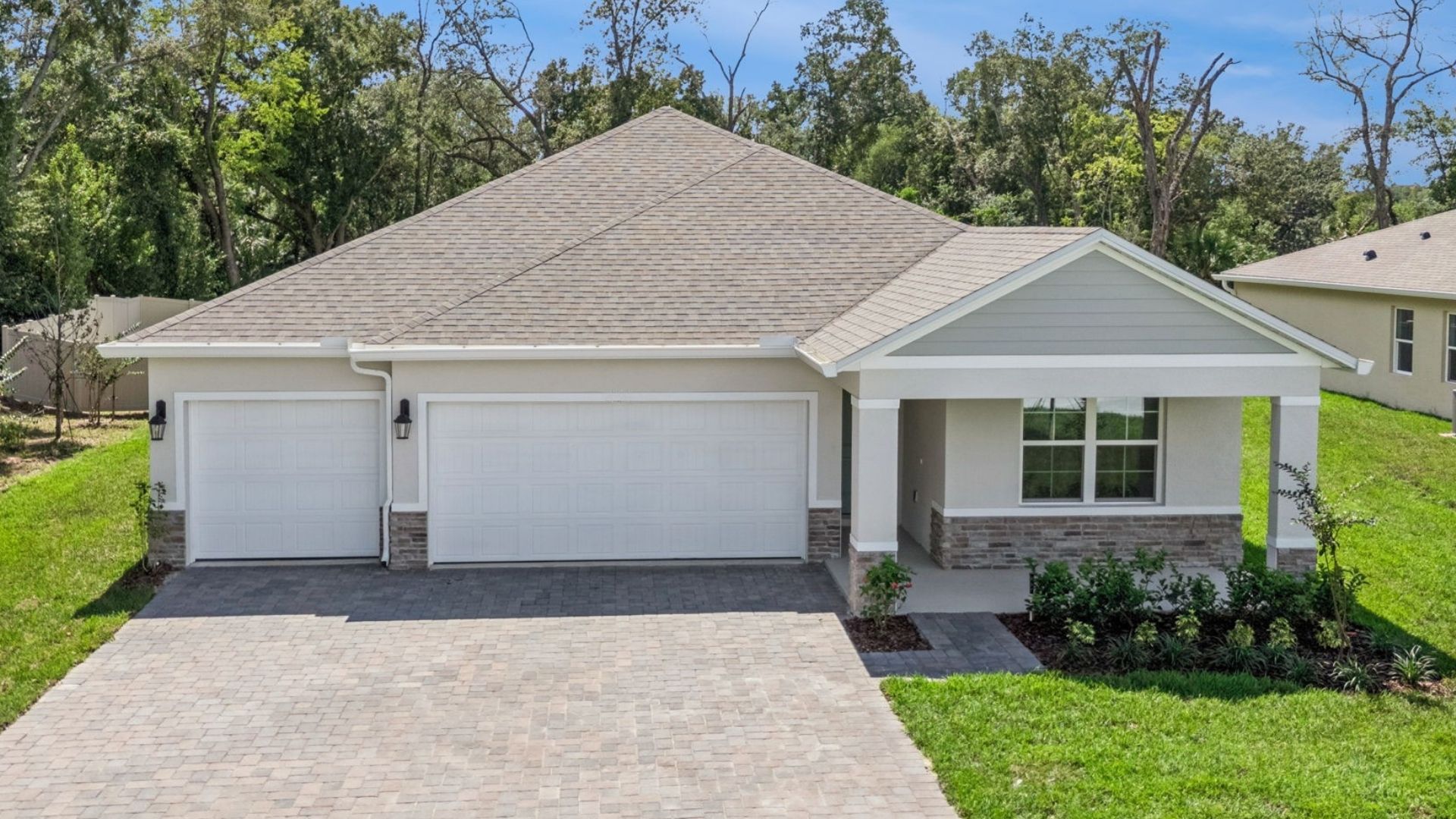 Single story new home with large windows and 2 car garage.