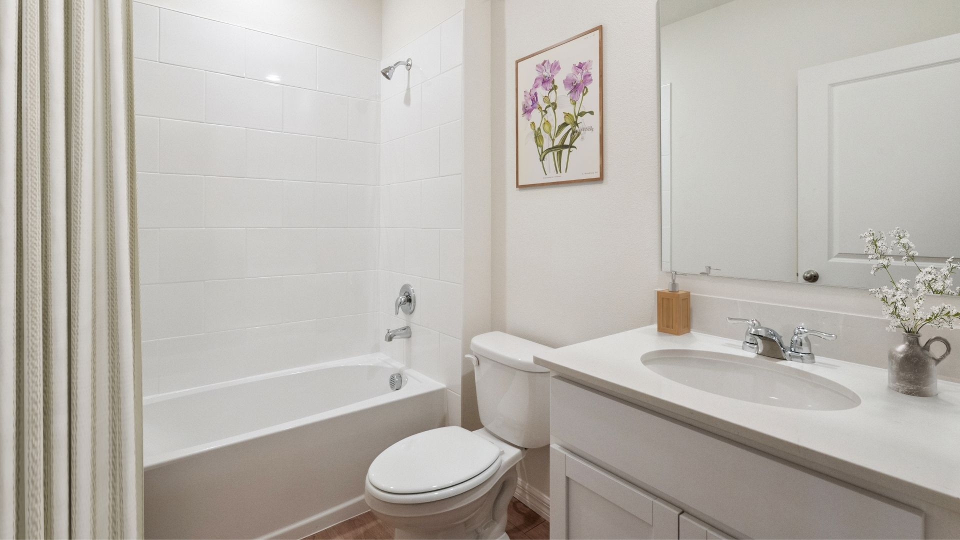 Modern bathroom with double vanity, large wall mirror, cabinets and quartz countertops