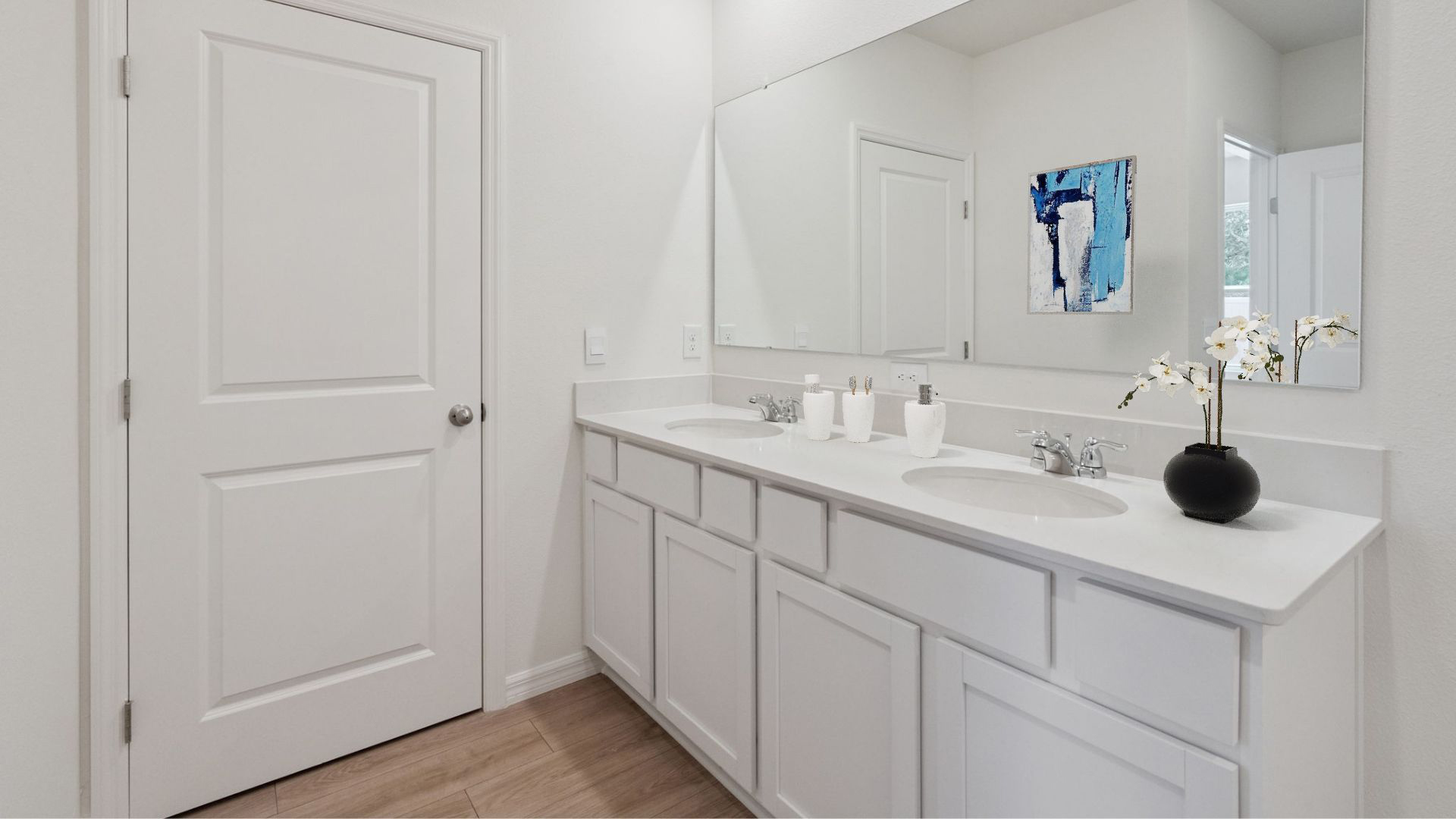master bathroom showing double vanity with quartz countertops with access to walk-in closet.