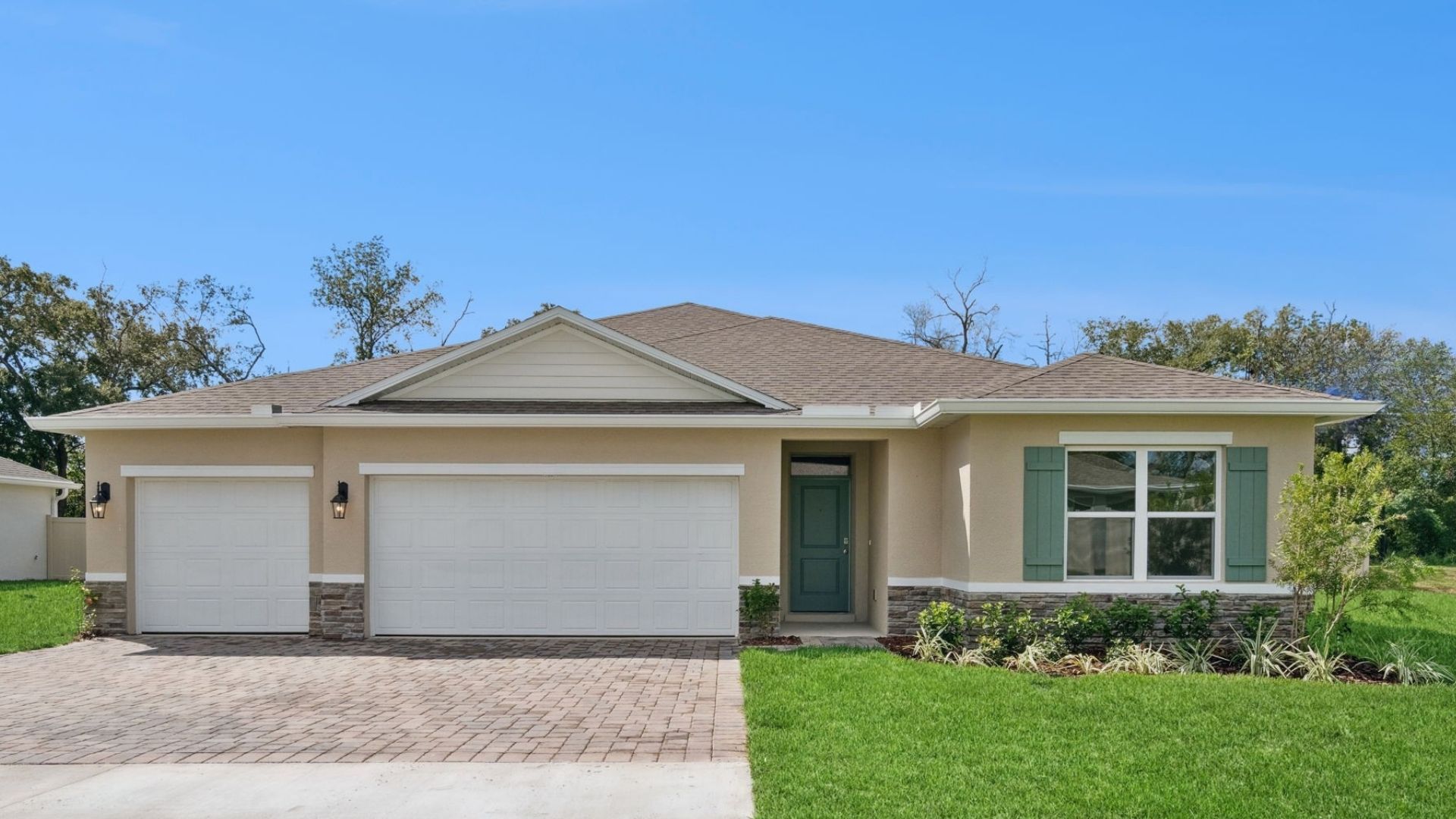 Single story new home with large windows and 2 car garage.