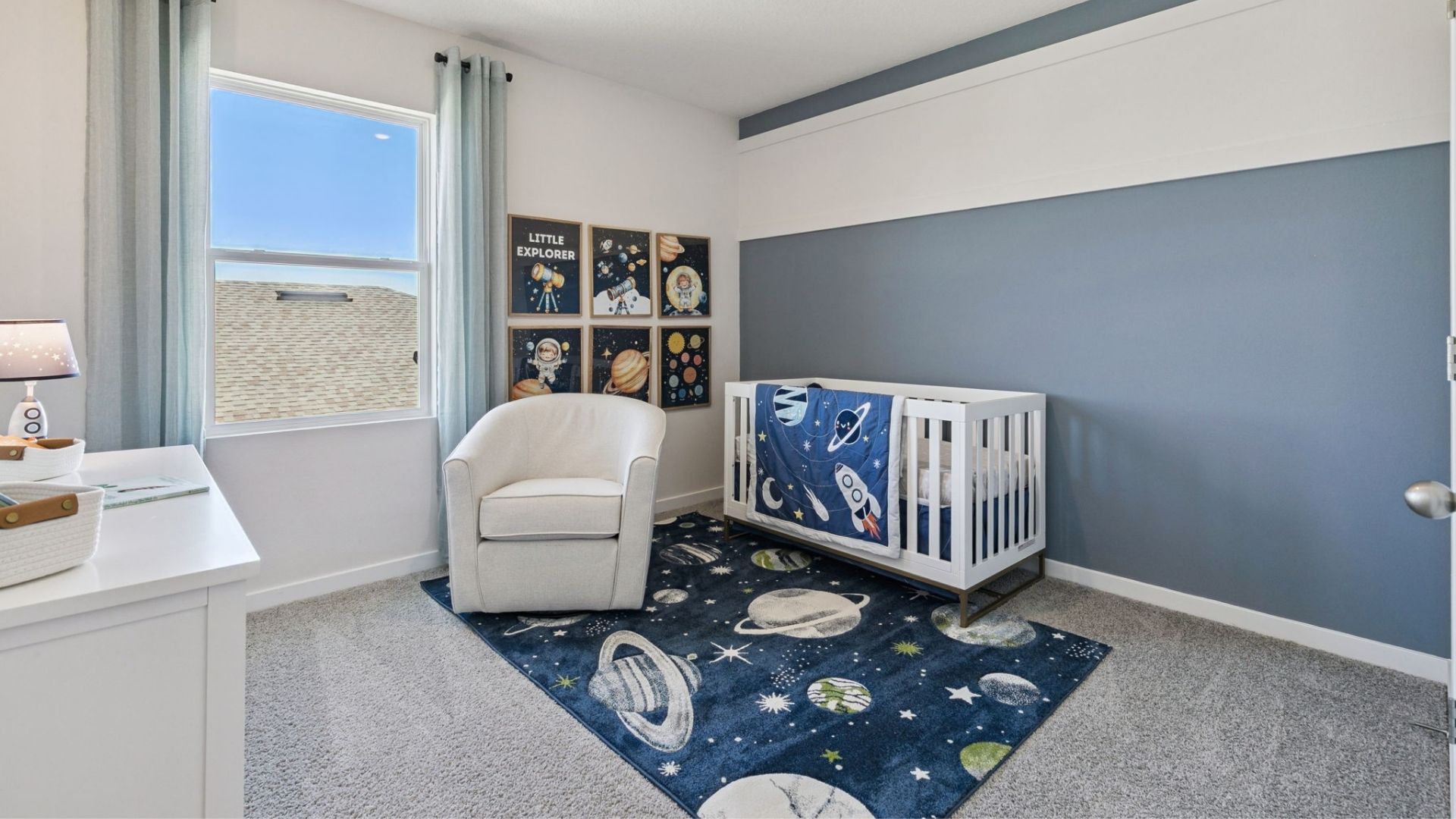 Spacious primary bedroom with king size bed, carpet flooring, natural lighting.