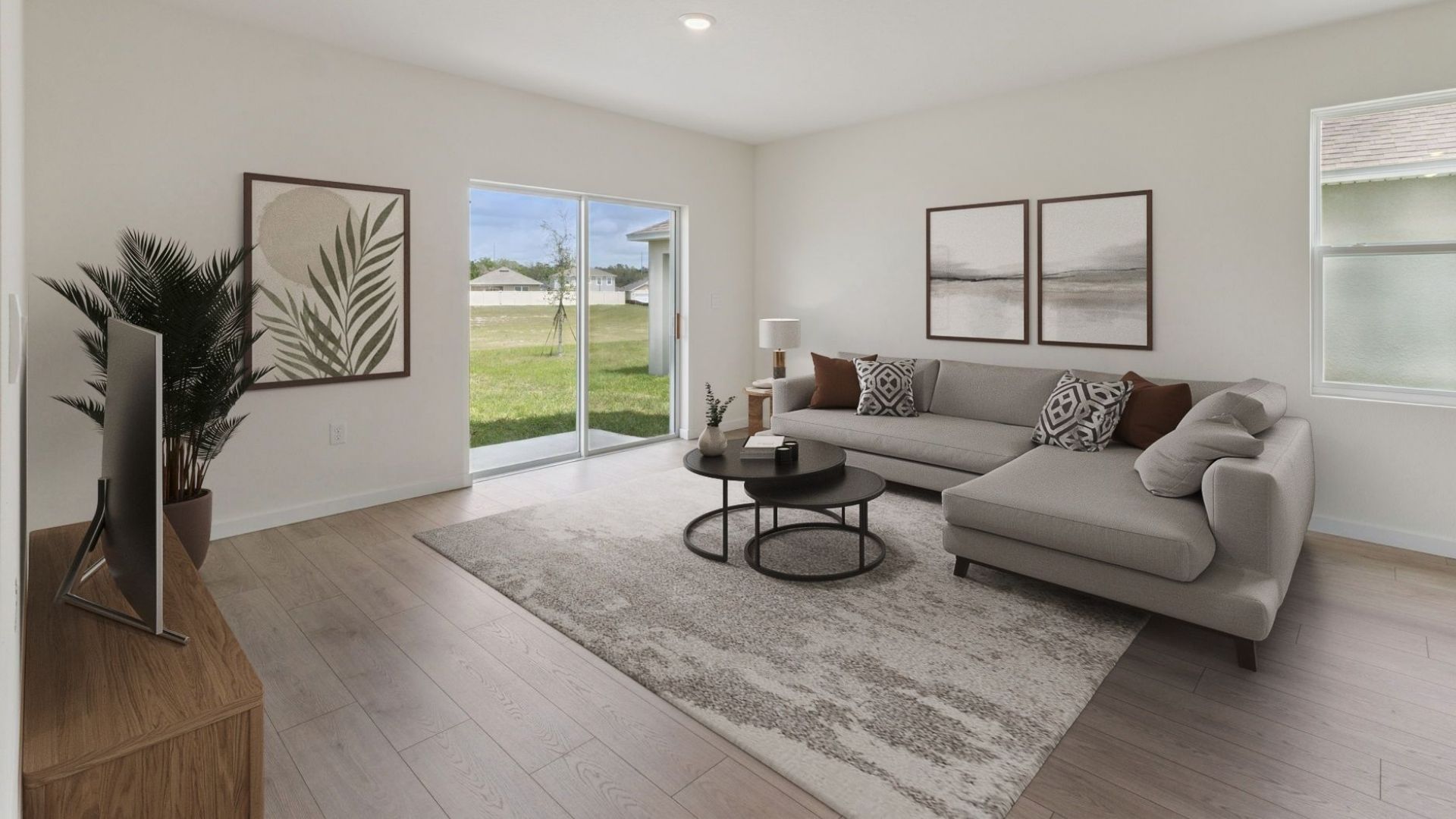 Living area with couch seating, entertainment system and natural lighting