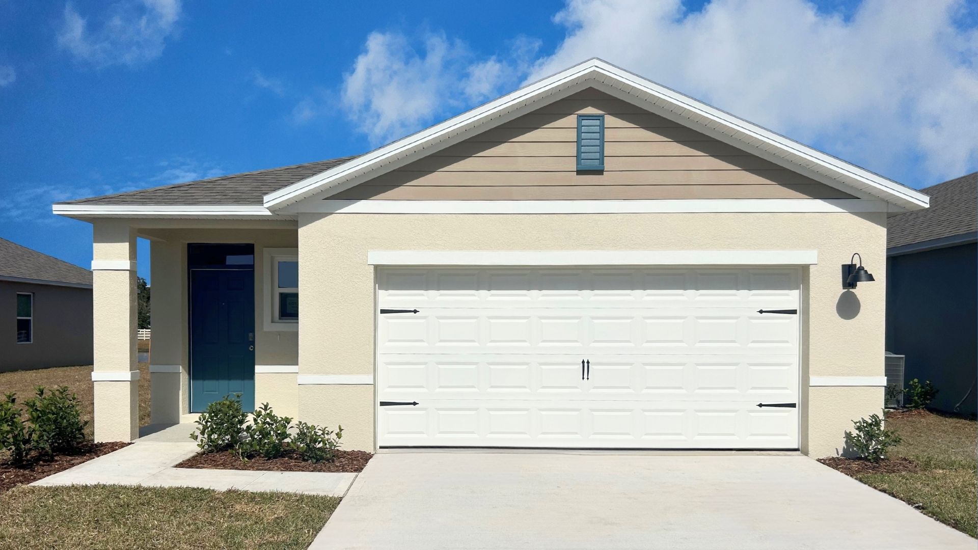 Single story new home with large windows and 2 car garage.