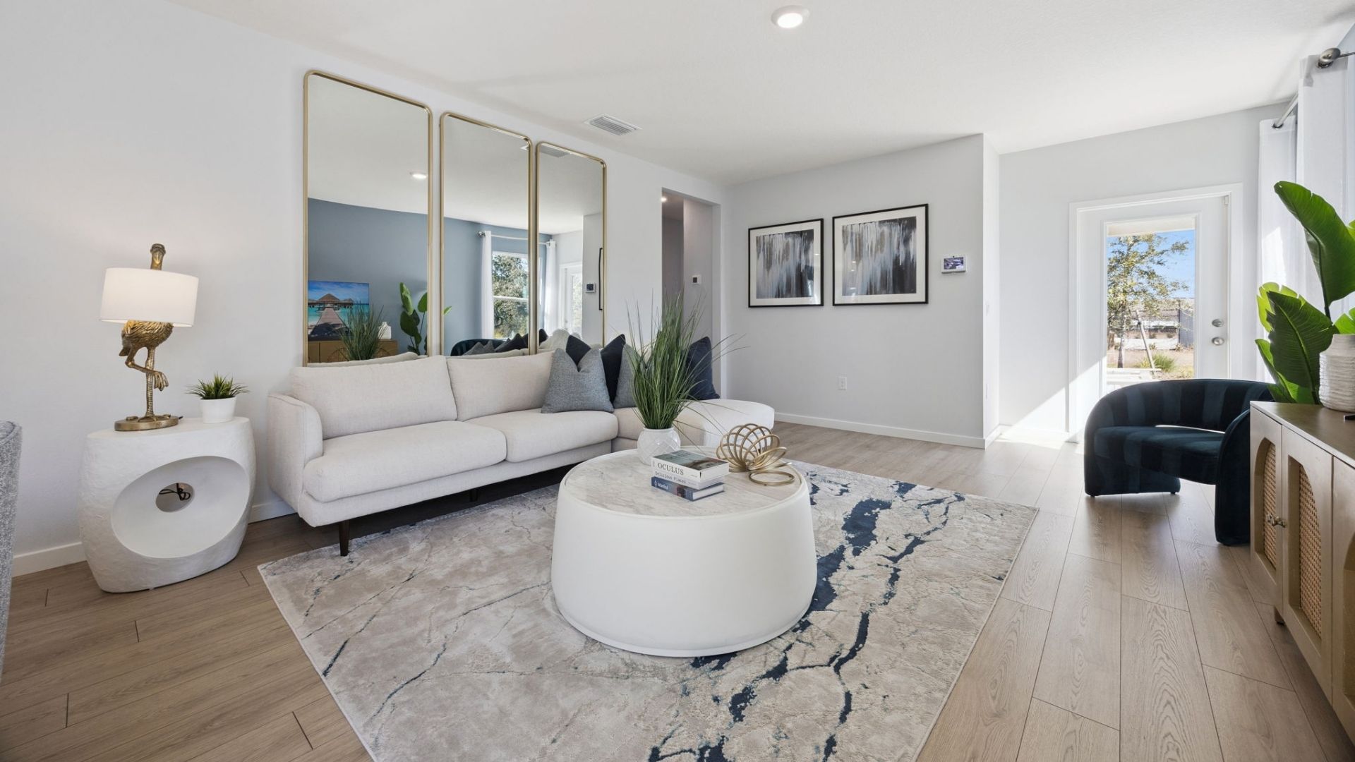 Living area with couch seating, entertainment system and natural lighting overseeing kitchen and dining room