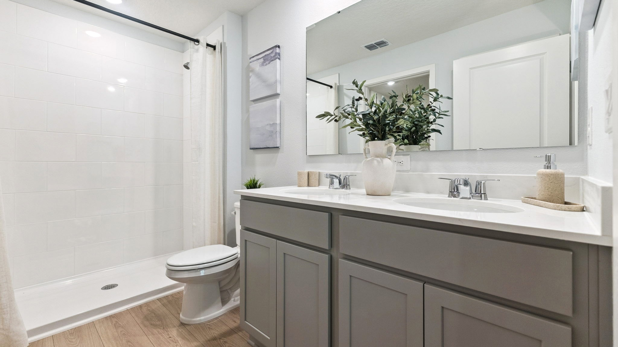 Guest bathroom with single vanity quartz countertops, toilet and shower.