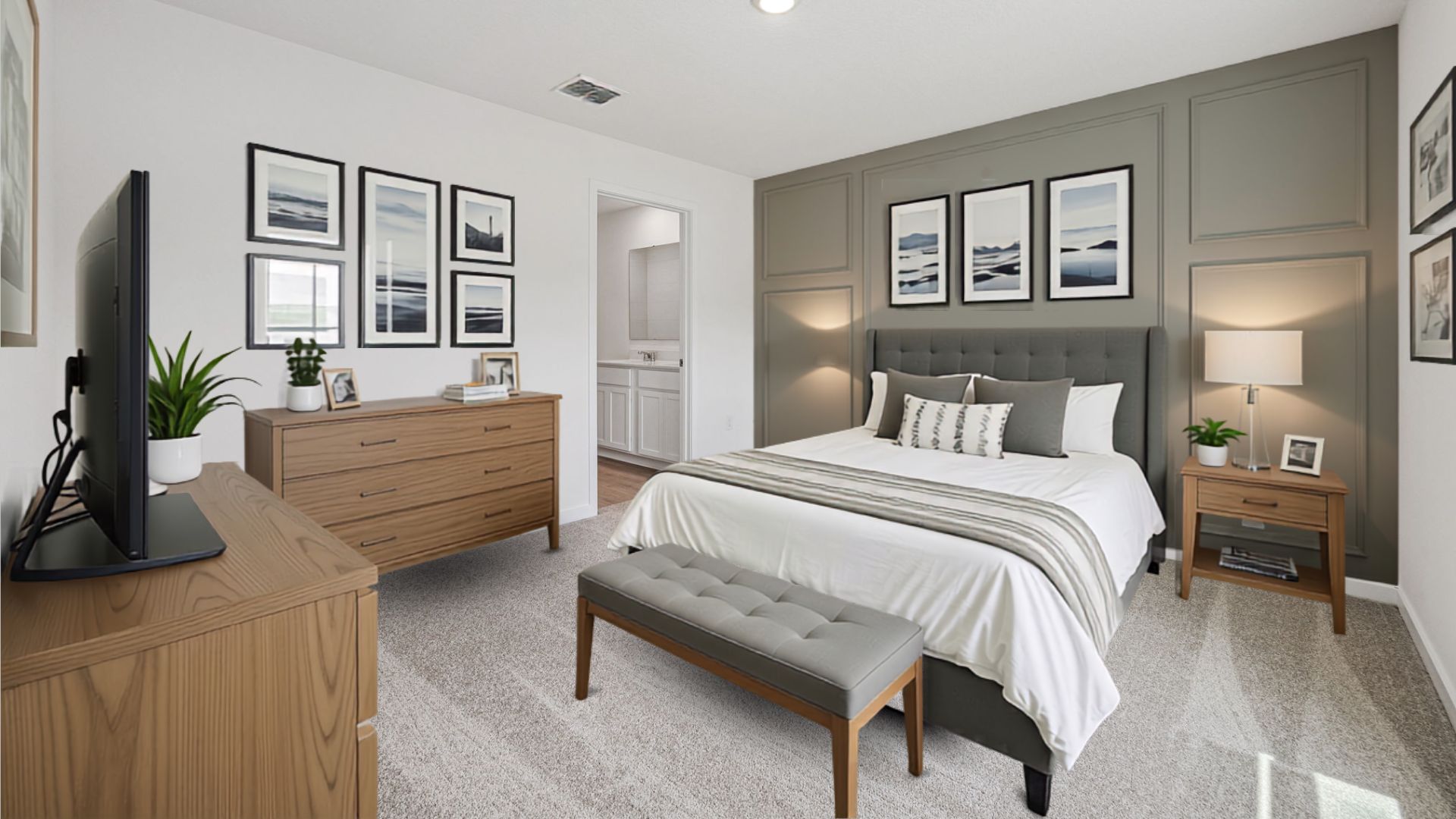 Spacious primary bedroom with king size bed, carpet flooring, natural lighting.