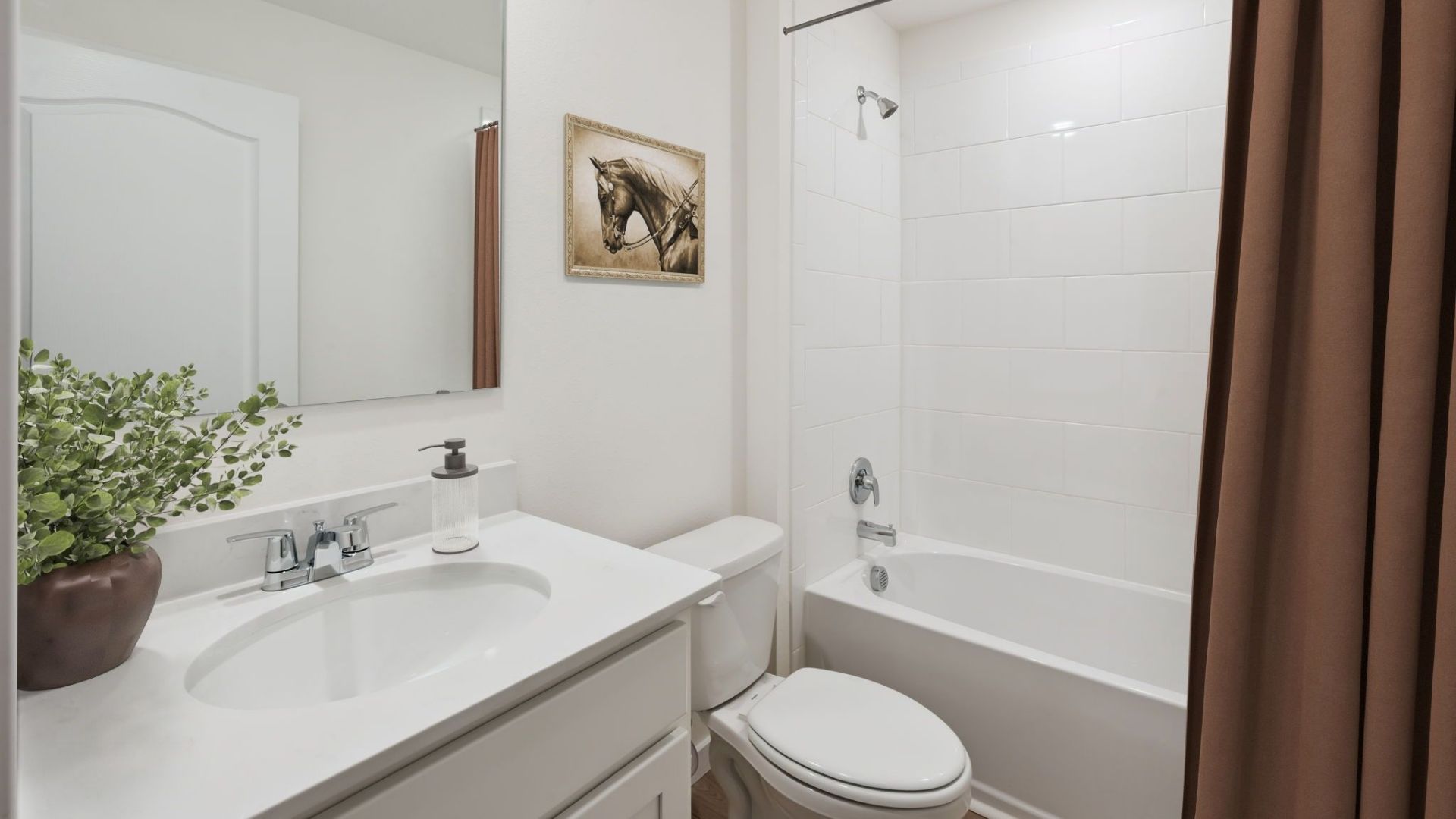 Spacious primary bedroom with king size bed, carpet flooring, natural lighting.