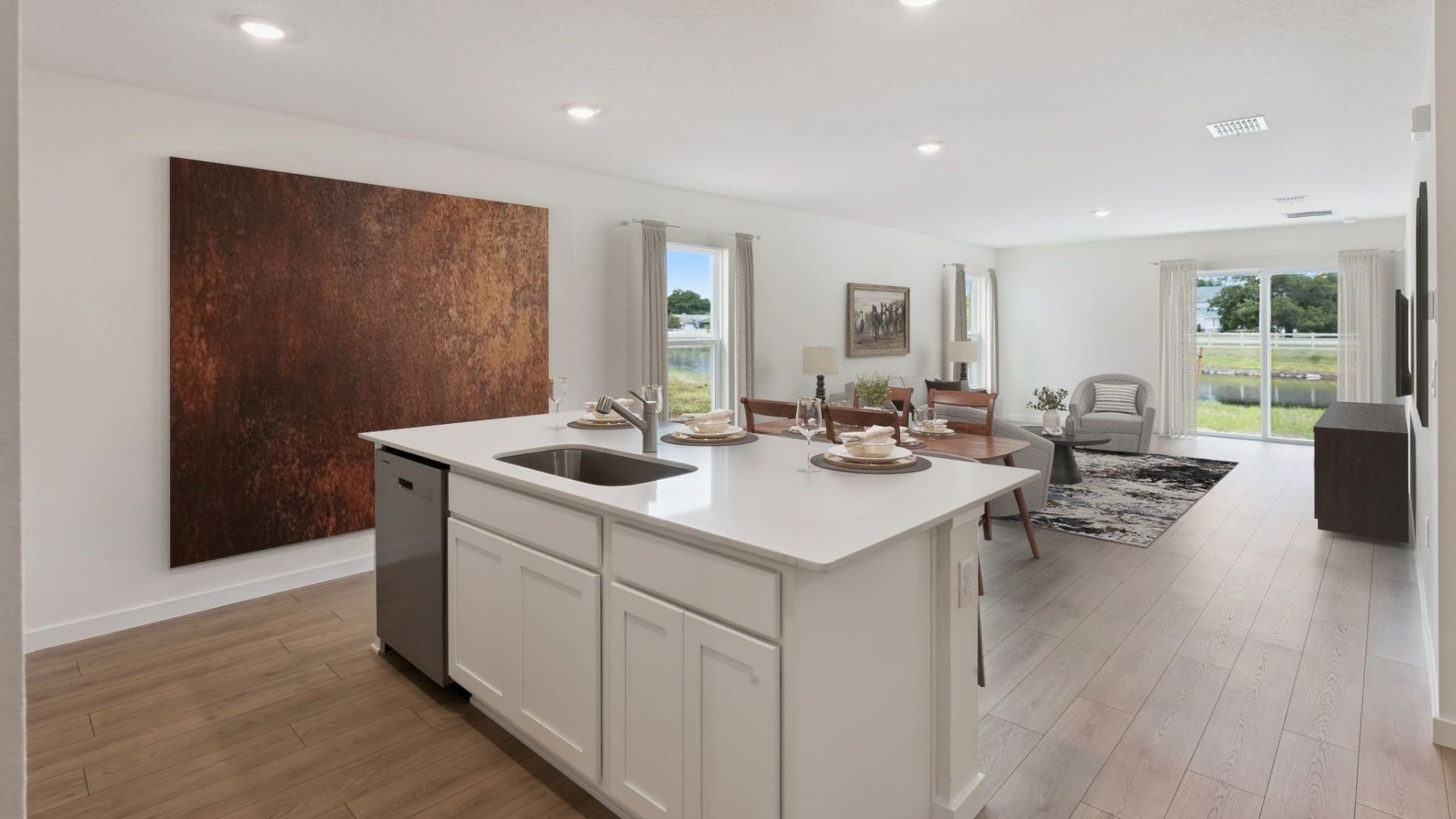 Living area with couch seating, entertainment system and natural lighting