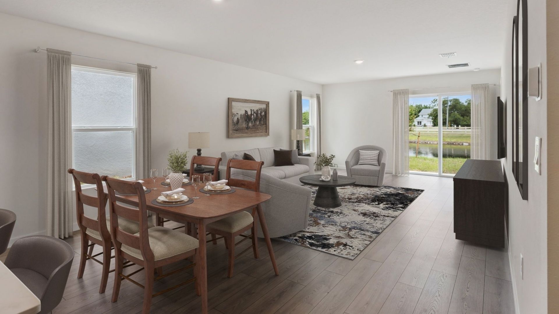 Living area with couch seating, entertainment system and natural lighting