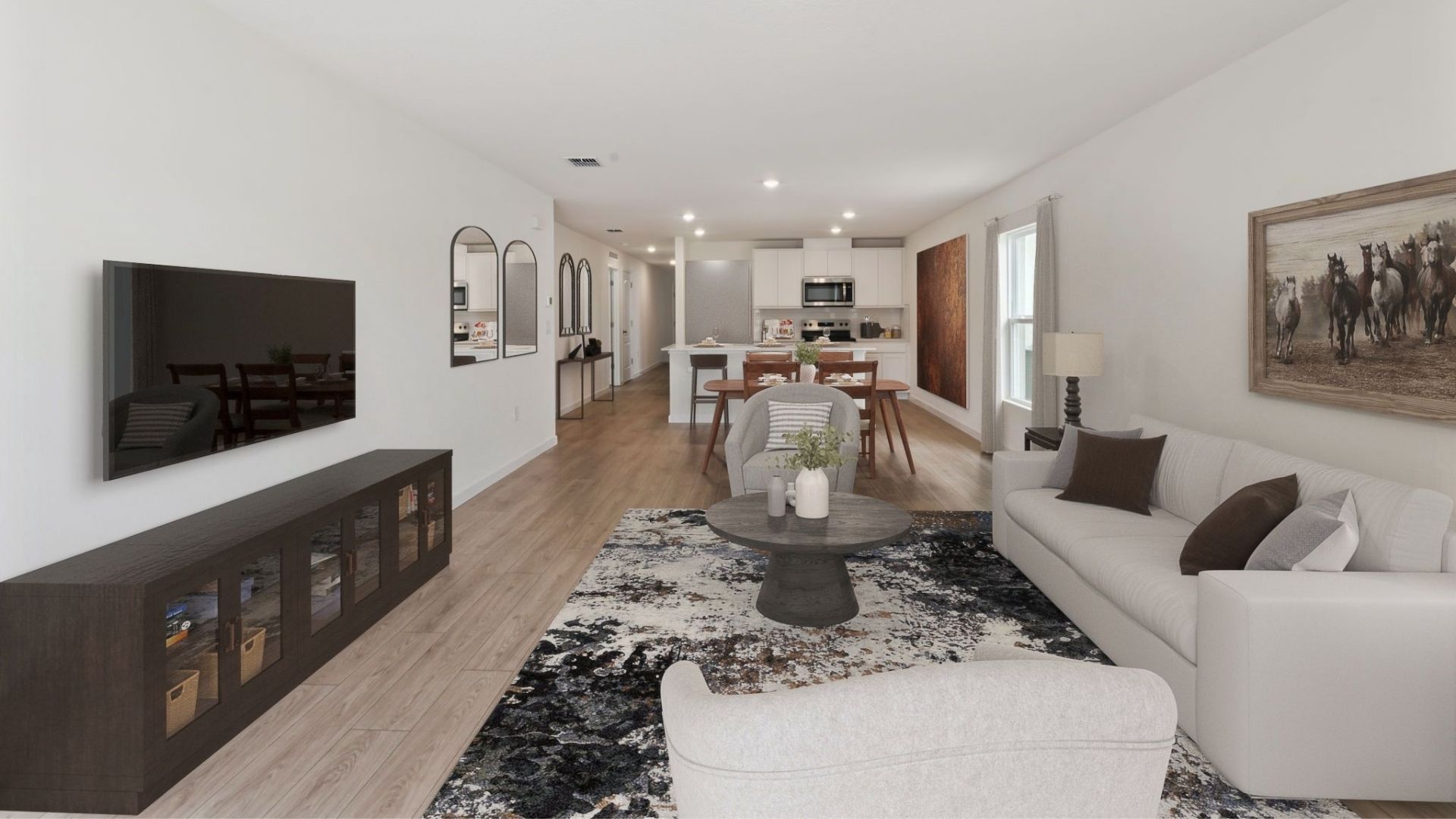 Living area with couch seating, entertainment system and natural lighting