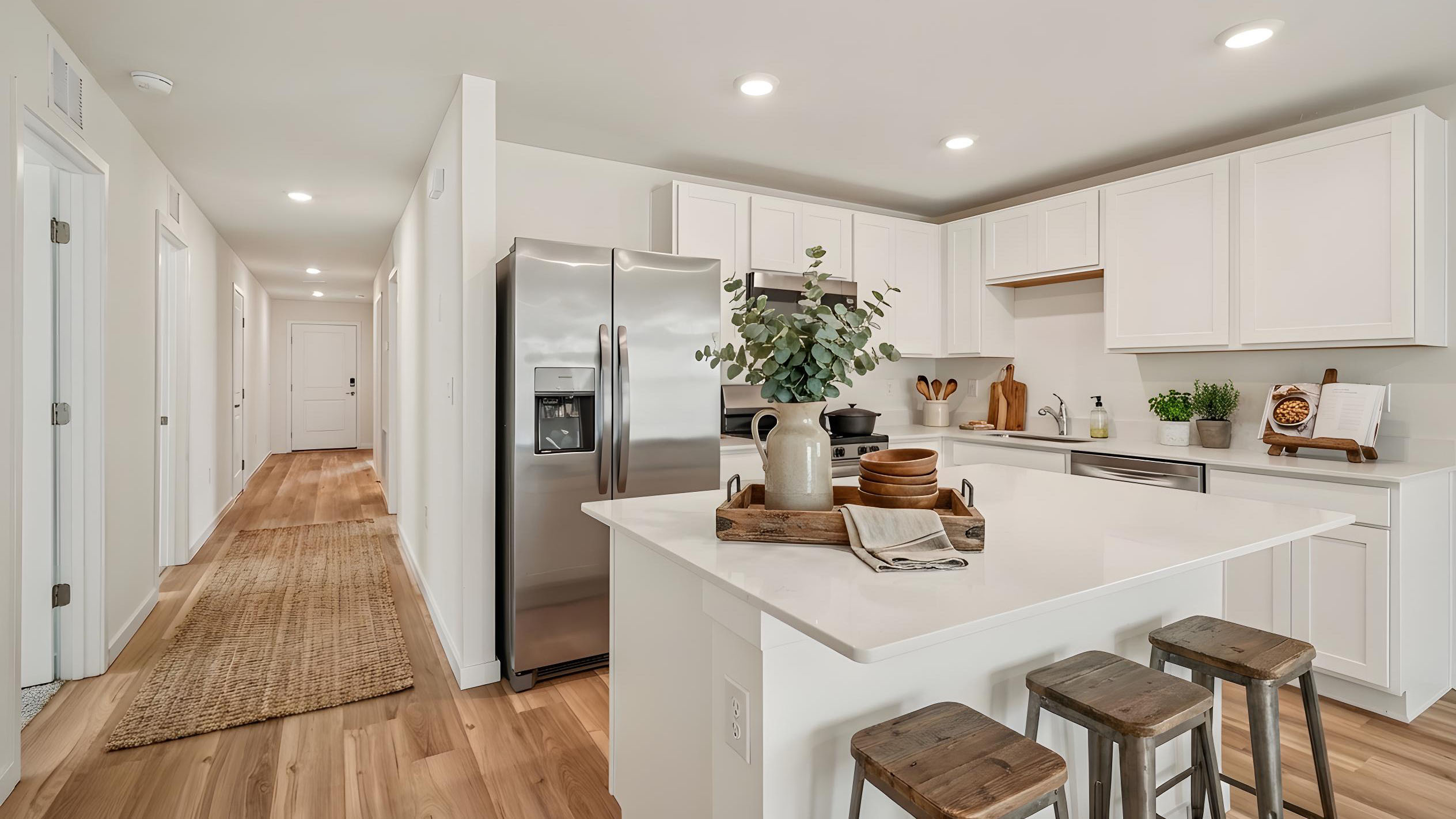 kitchen with quartz countertops overseeing living area and dining room table