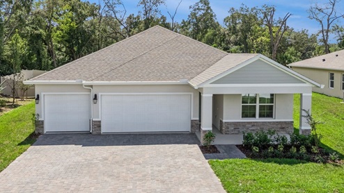 Single story new home with large windows and 3 car garage.