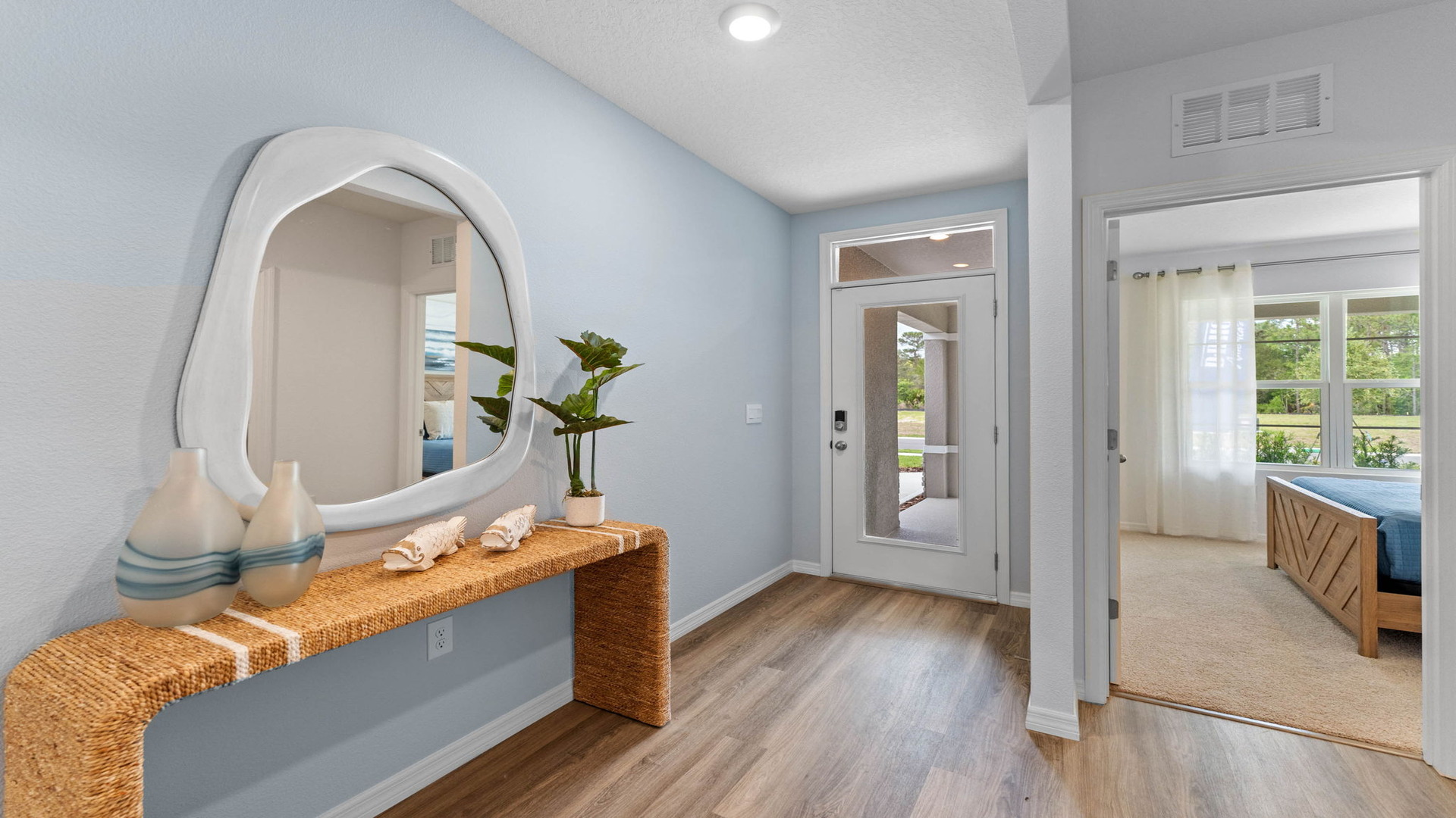 Entry way with luxury vinyl plank flooring showing front door.