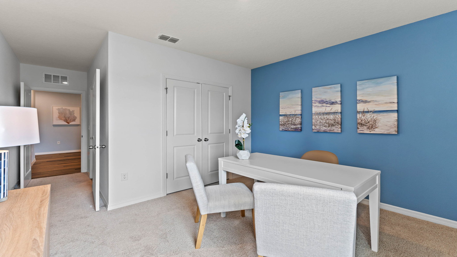 Functional home office with desk, chairs and space to work or play.