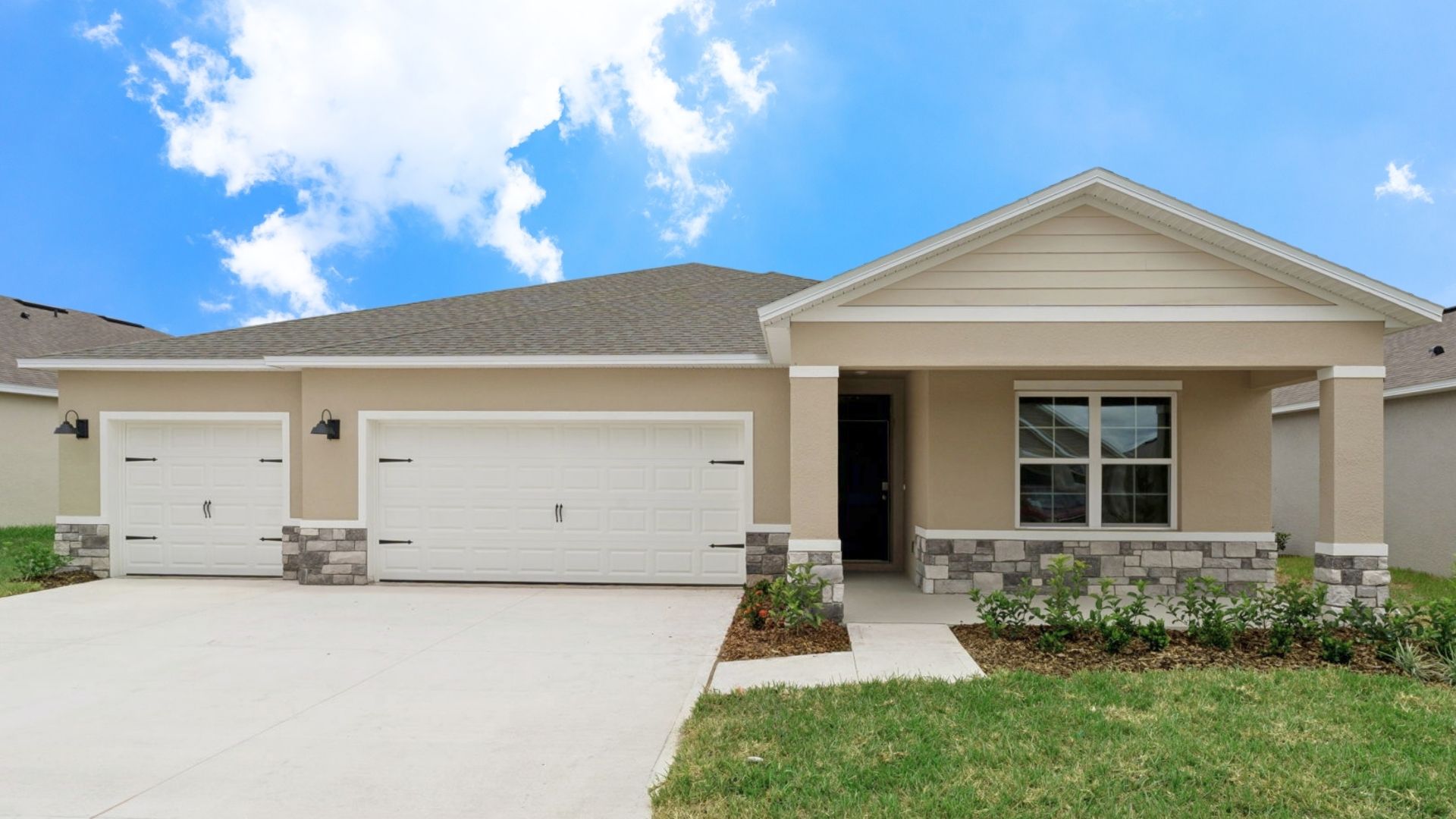 Single story new home with large windows and 2 car garage.