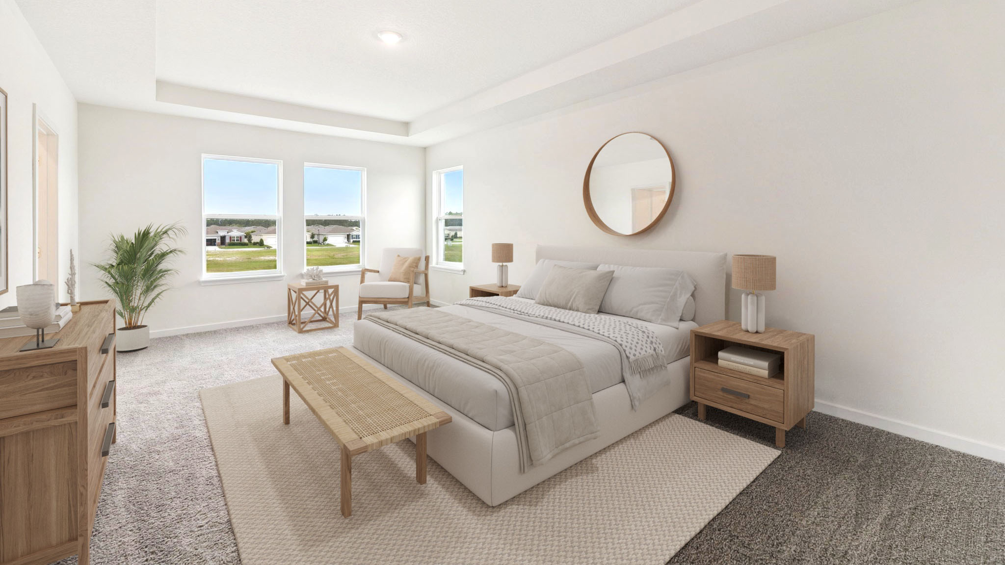 Spacious primary bedroom with king size bed, carpet flooring, natural lighting.
