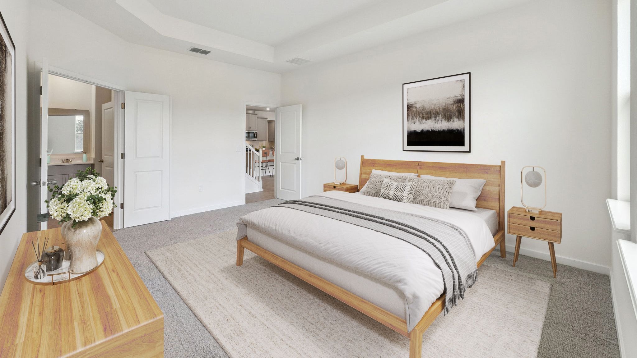 Spacious primary bedroom with king size bed, carpet flooring, natural lighting.