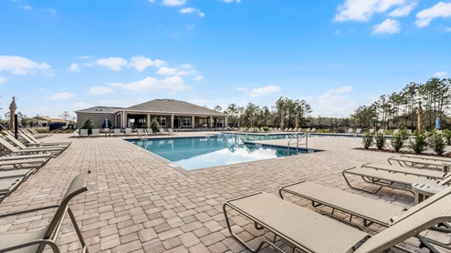 Cool off in the gated community pool, surrounded by lush landscaping