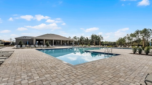 Sunny day at the community swimming pool with lounge seating.